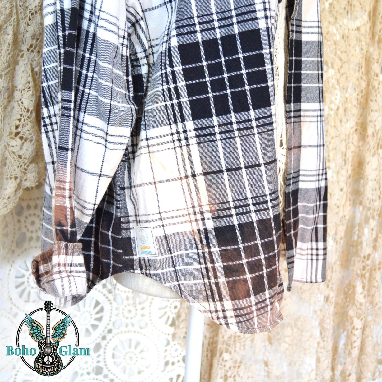 Hem Detail: A side view of the shirt showing the dip-bleached hemline and the custom Boho Glam brand label near the bottom edge.