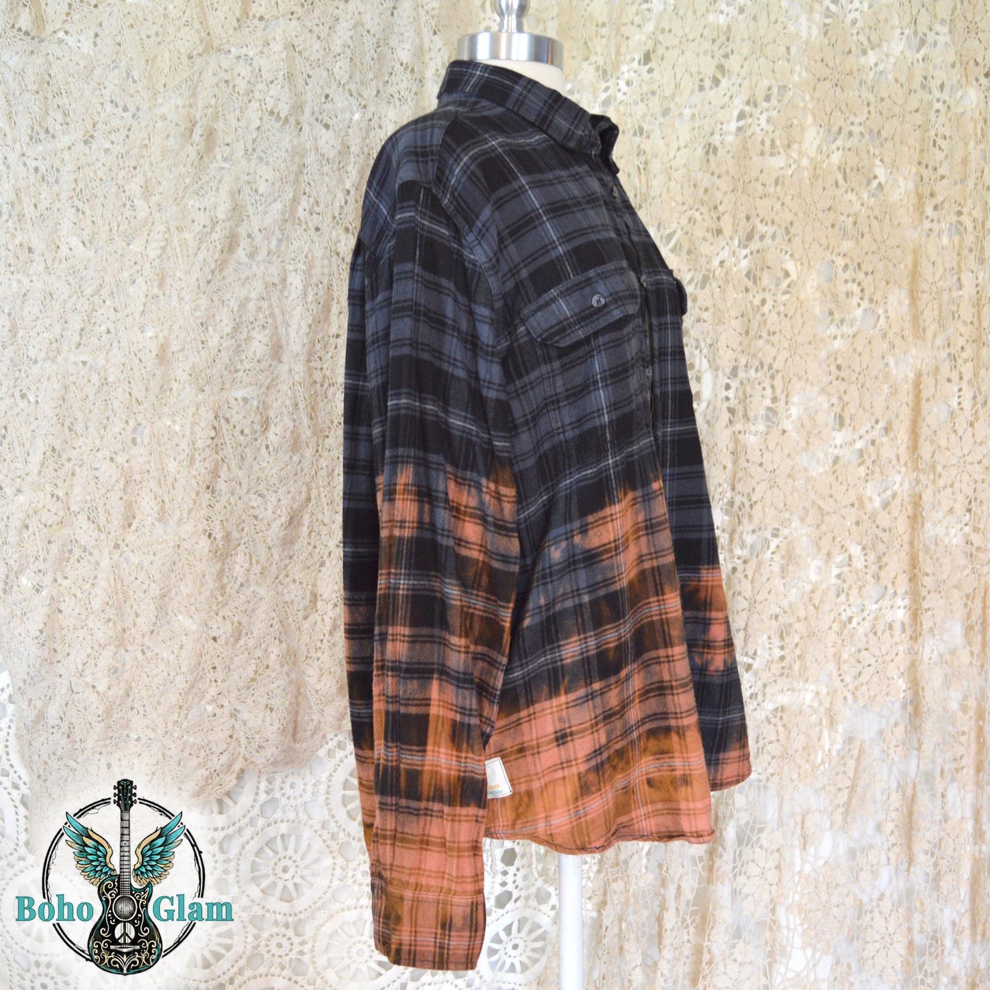 mannequin display showing the long sleeves and the striking color transition from dark charcoal plaid to bleached orange.
