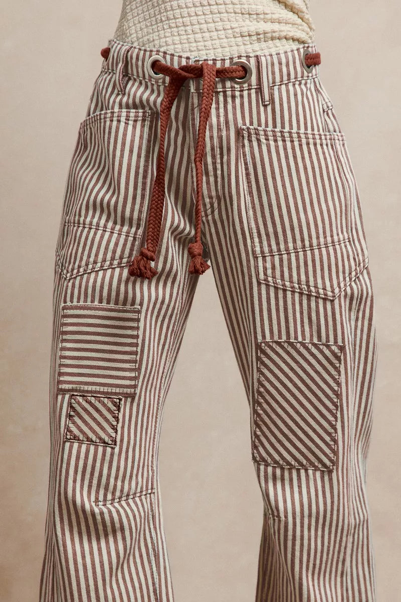 Striped pants with a drawstring on a beige background