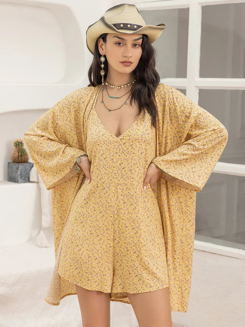 Woman wearing a yellow dress and cowboy hat indoors