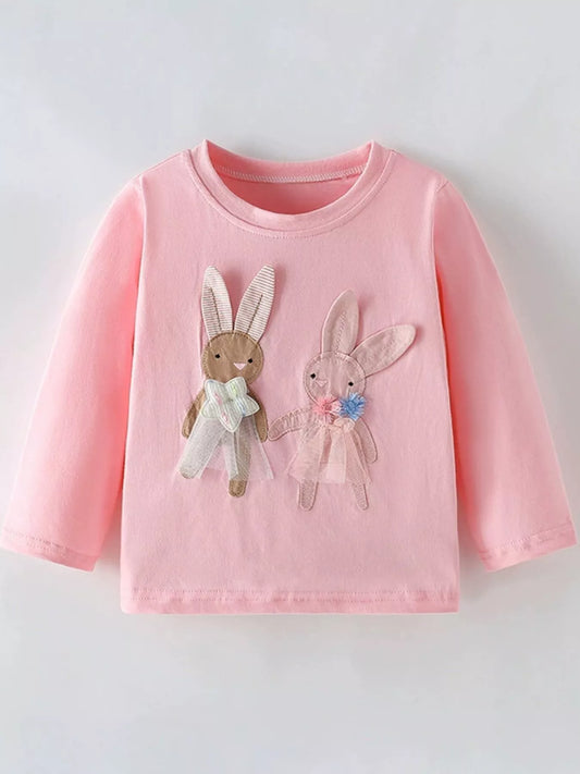Pink long-sleeve shirt with bunny appliqués on a light gray background