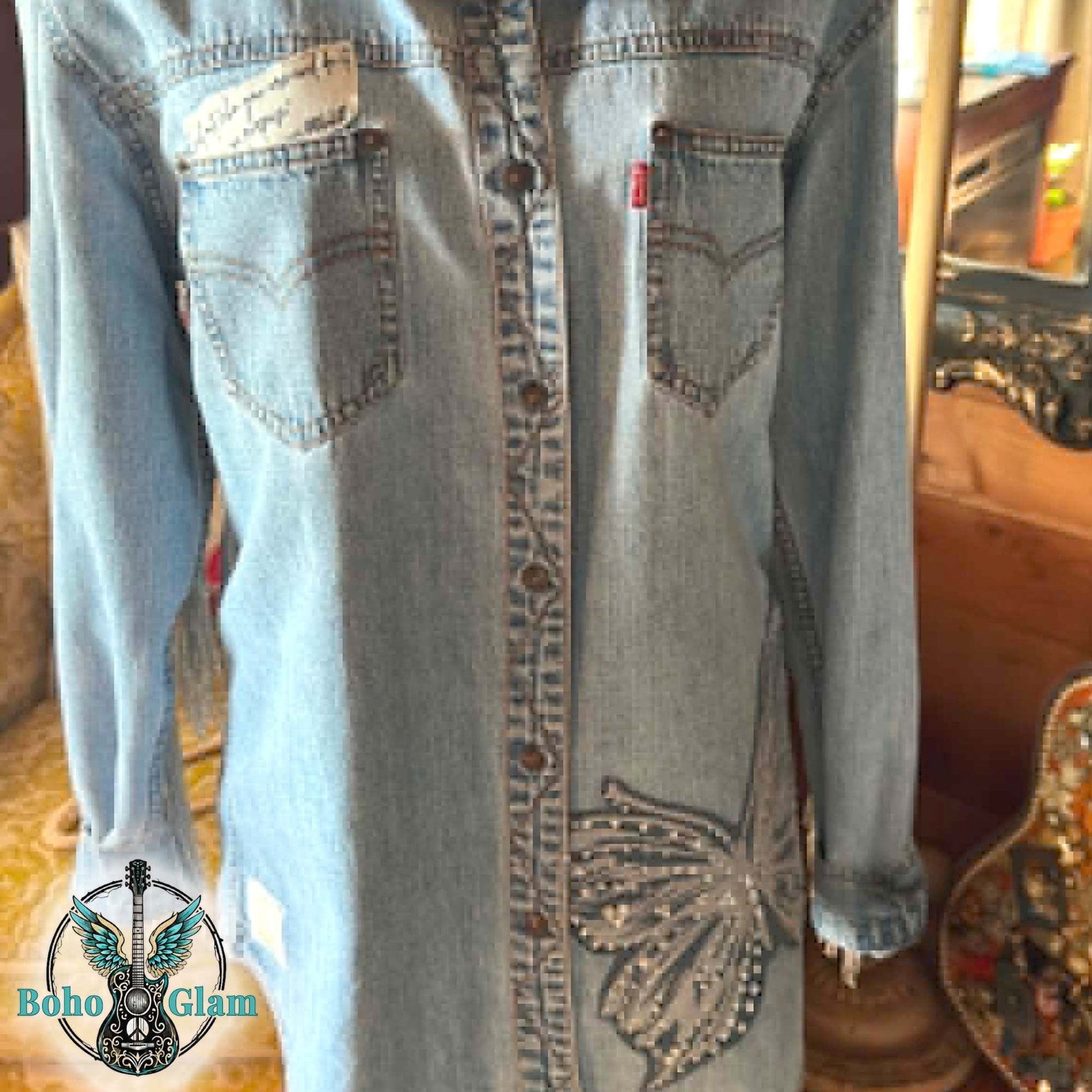 Denim shirt with decorative elements on a blurred background