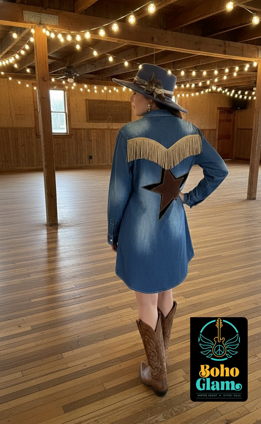 Person wearing a blue cowboy jacket with a star design and fringe, standing in a wooden interior space.