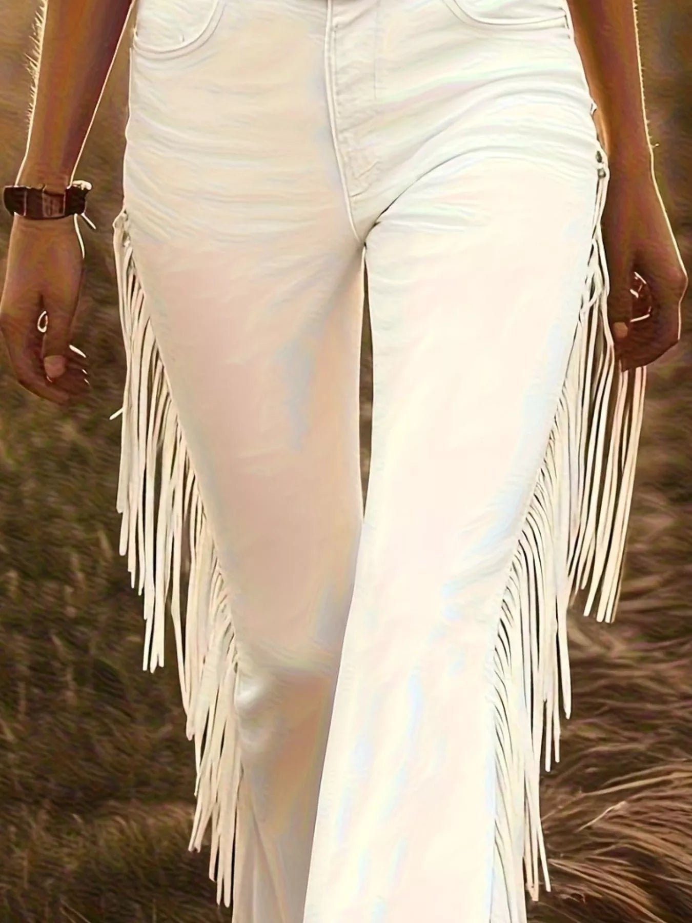 White fringed pants worn by a person in a natural setting
