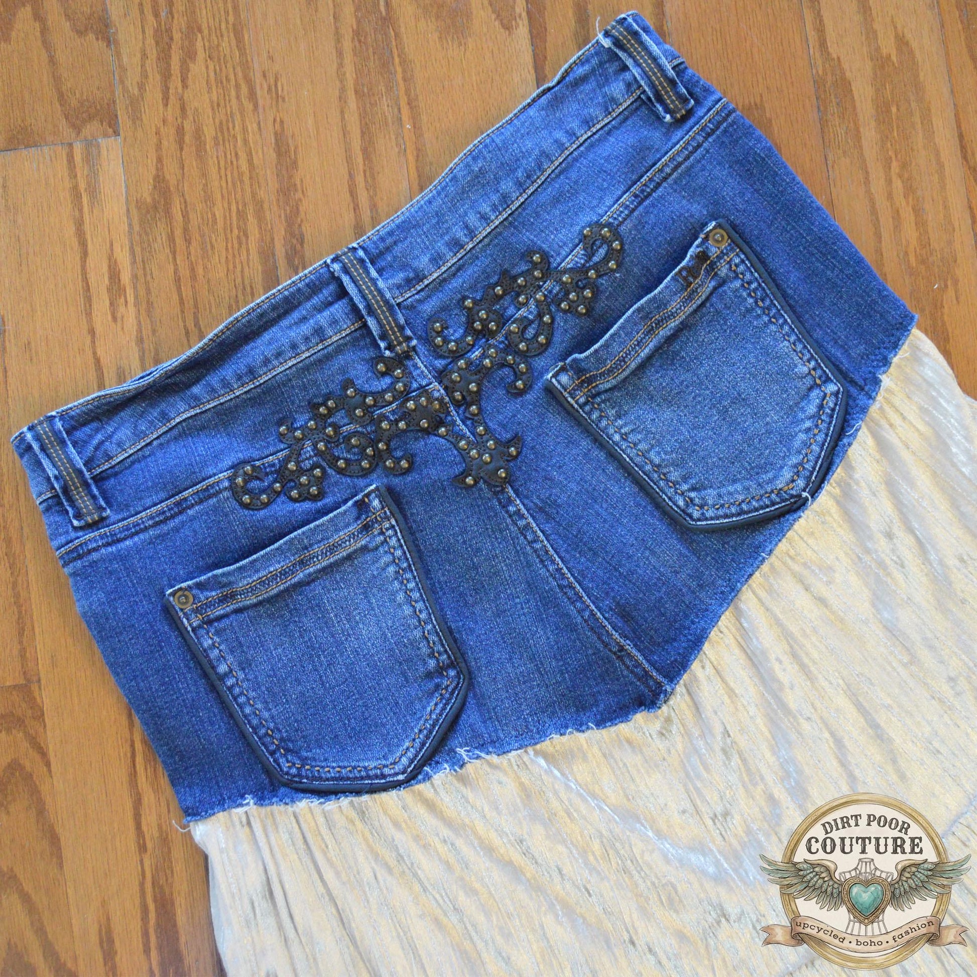Rear view of the skirt on the mannequin, highlighting the authentic denim stitching and the studded detailing on the back pockets