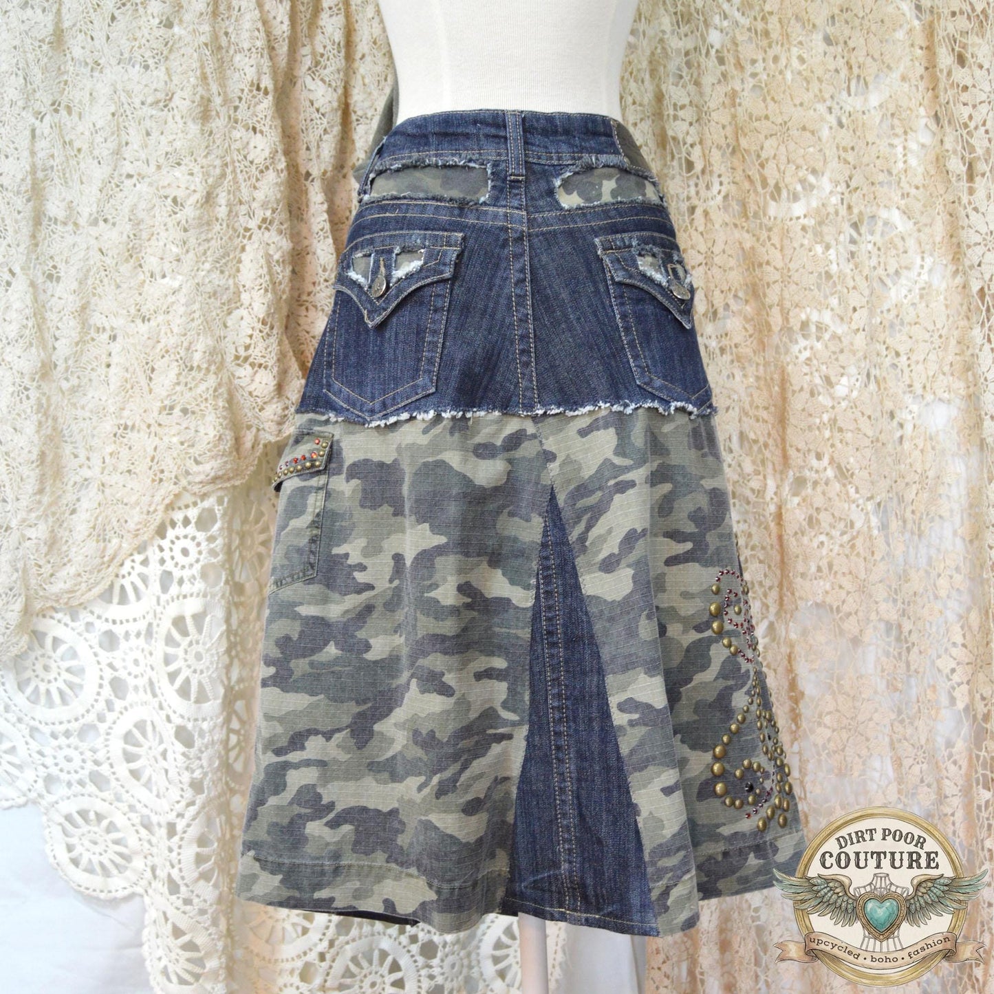 The back of the denim skirt showing the tailored fit and continuation of the camo accents and structural stitching.
