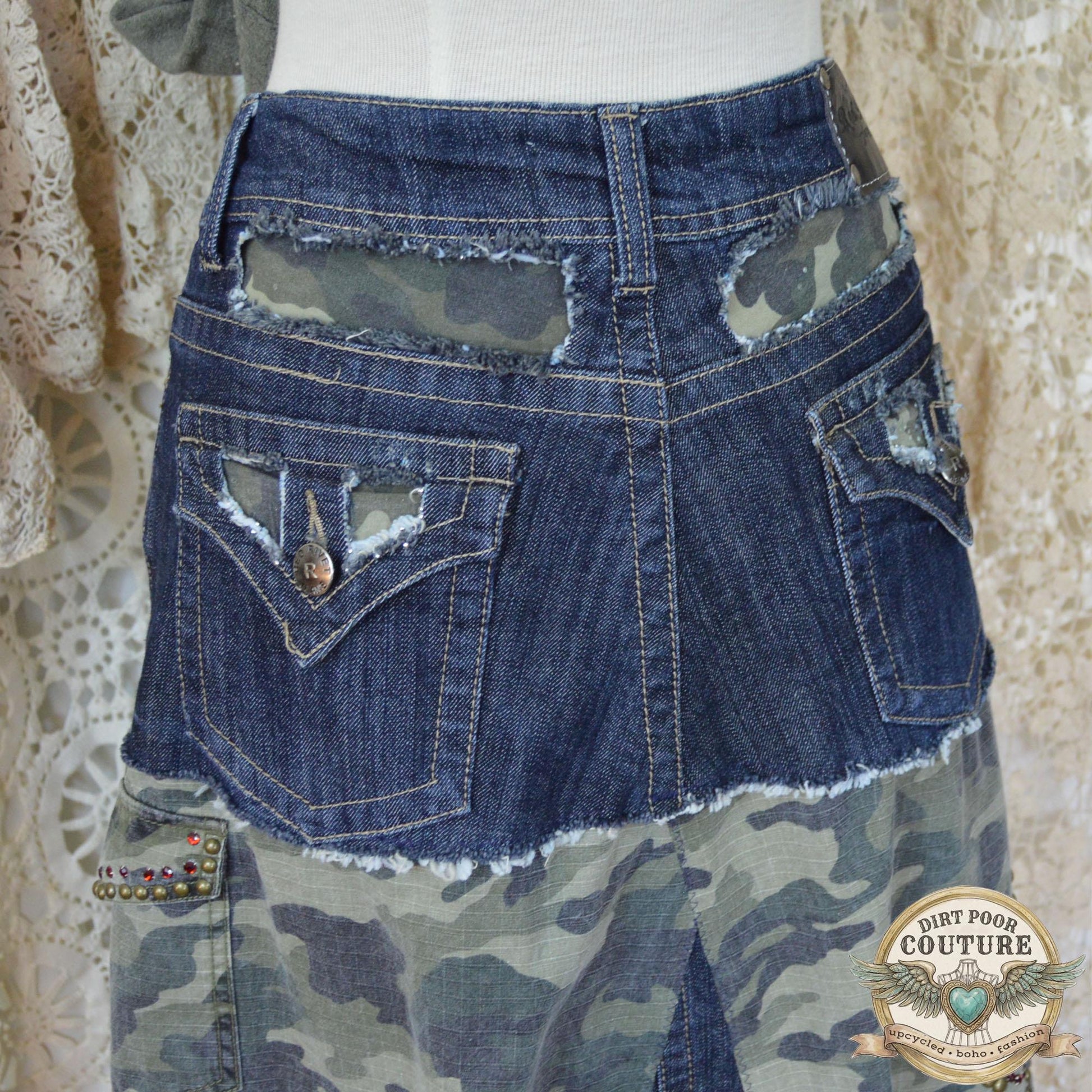 Close-up of the immaculate metal studding and sparkling rhinestone embellishments on the dark denim and camouflage background.