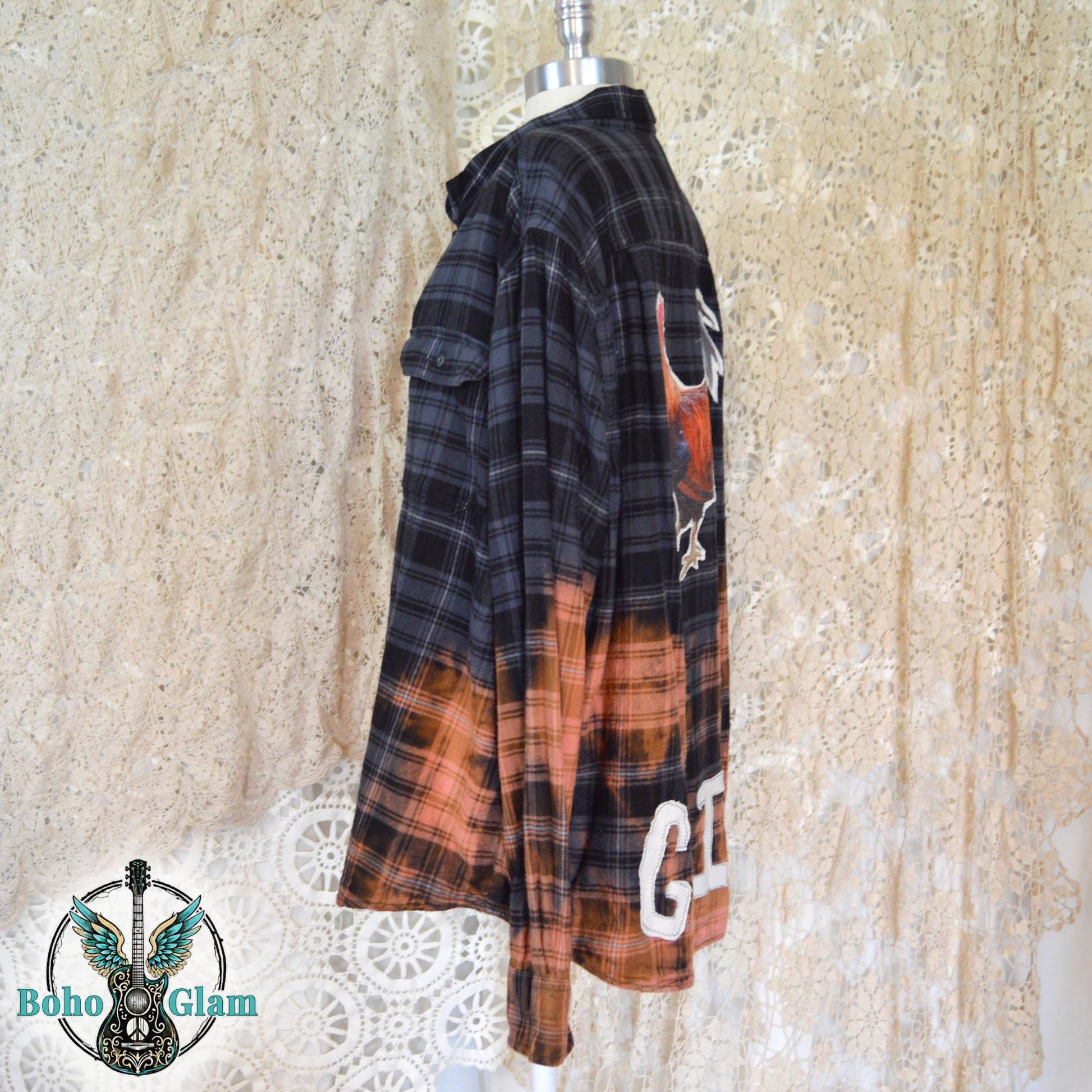 mannequin display showing the long sleeves and the striking color transition from dark charcoal plaid to bleached orange.