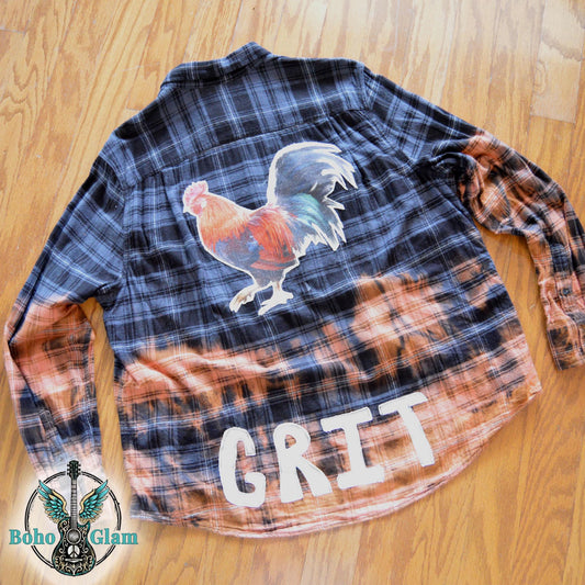 Rear of the bleached flannel featuring a large colorful rooster applique and white patchwork letters spelling GRIT along the hem.