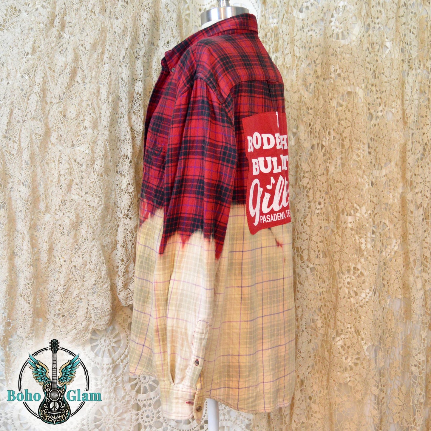 A profile shot of the shirt on a mannequin, showing the jagged, hand-dipped bleach line and the long sleeve with a button cuff.