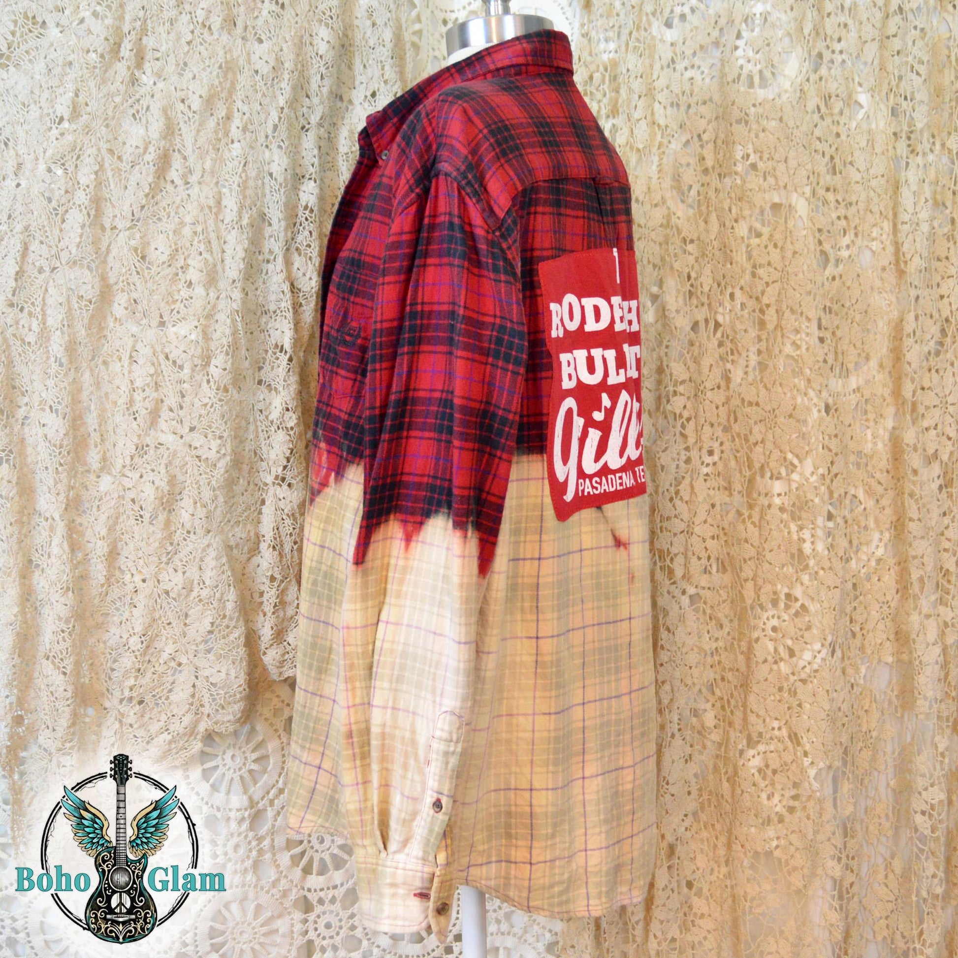 A profile shot of the shirt on a mannequin, showing the jagged, hand-dipped bleach line and the long sleeve with a button cuff.