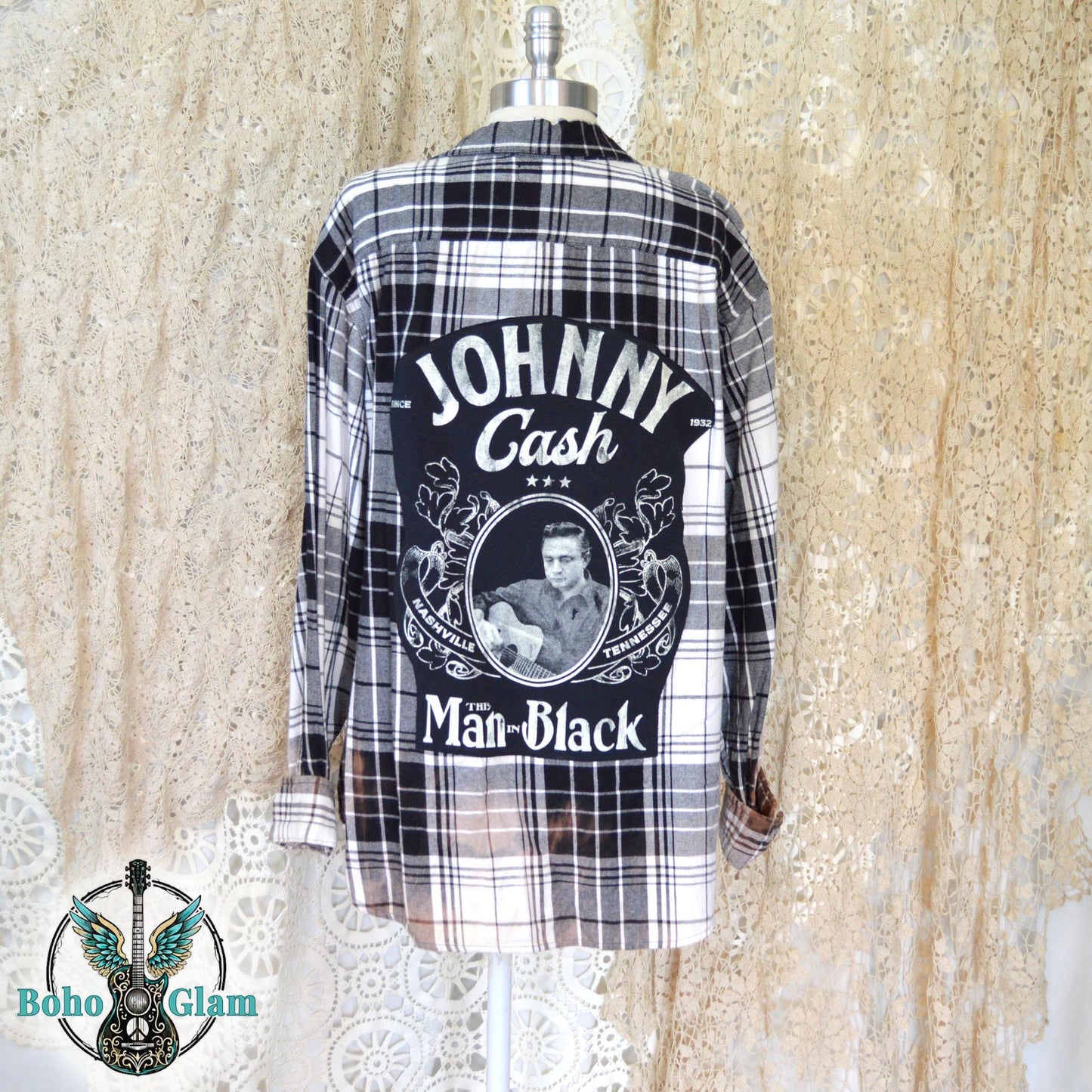 Full Back View: A black and white plaid flannel shirt on a mannequin featuring a large Johnny Cash Man in Black graphic applique on the back.