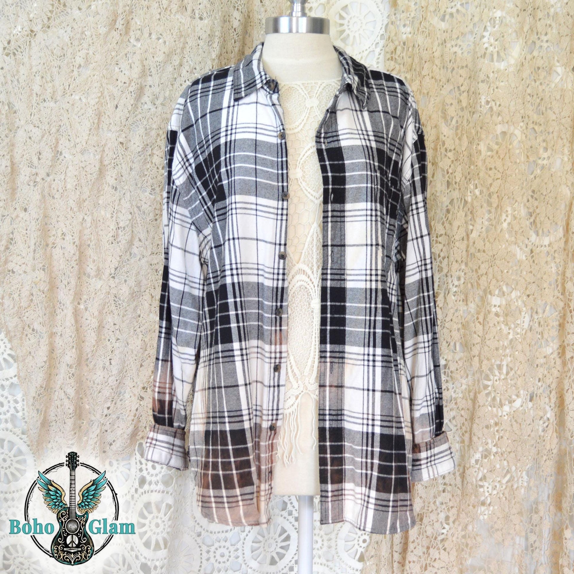 Front View: The front of the button down black and white plaid flannel shirt open on a mannequin showing the oversized fit and collar.