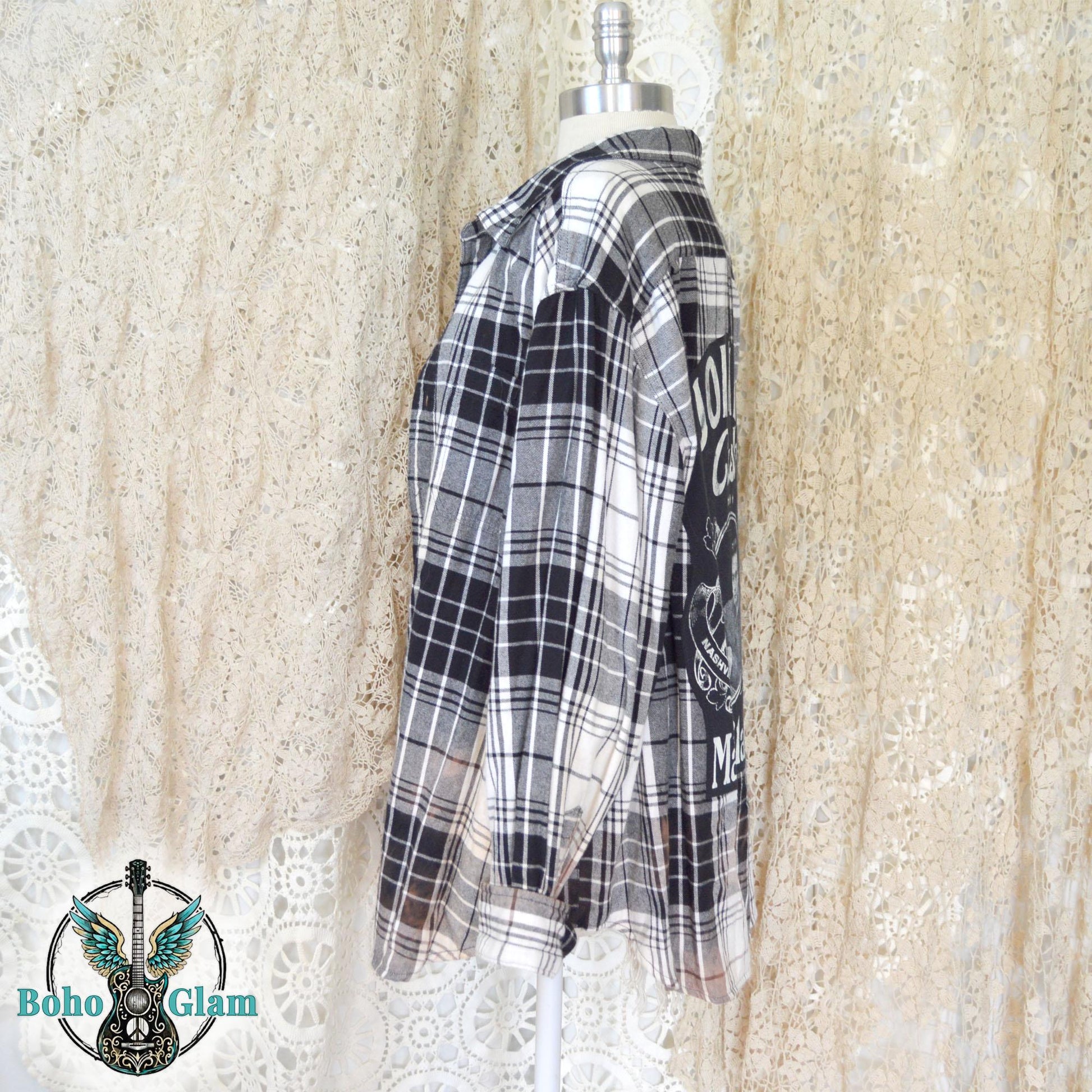 Side View: mannequin display of the oversized black and white plaid flannel showing the long sleeves and relaxed side profile.