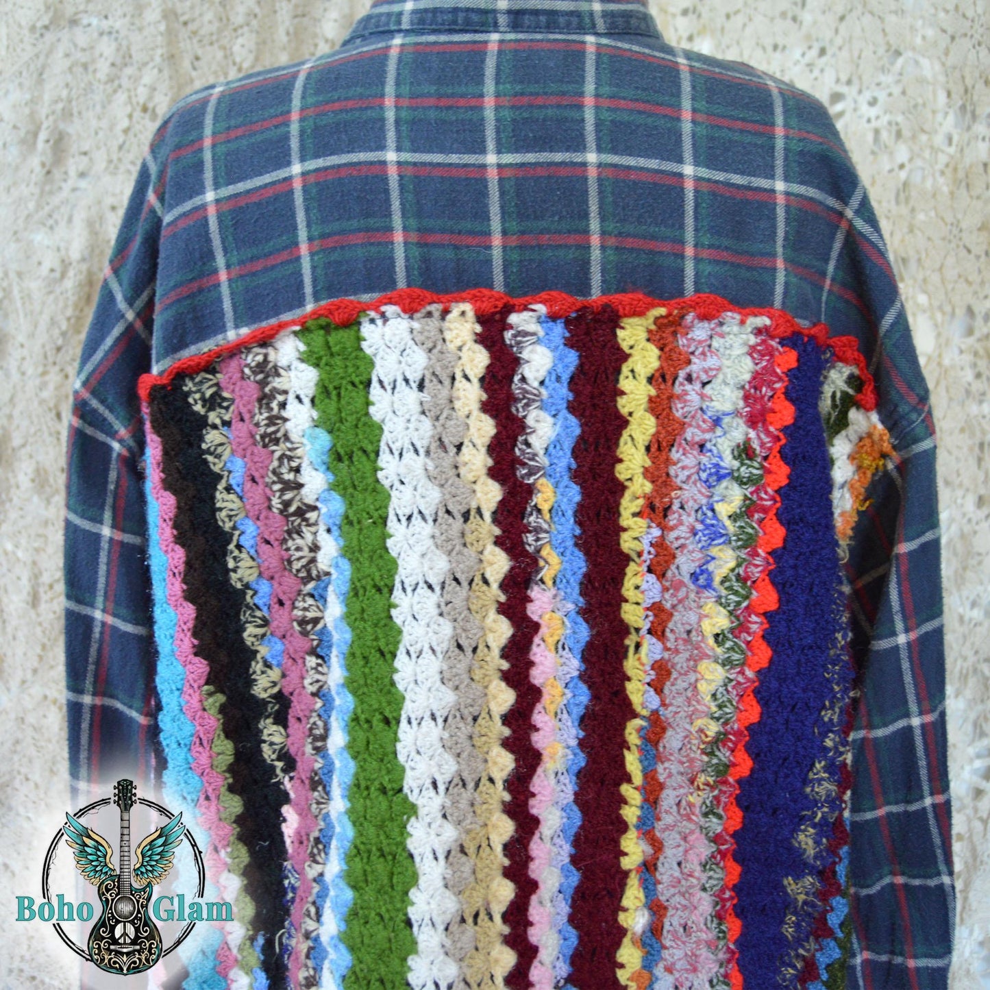 Close-up Back Detail: A detailed shot of the intricate crochet work on the back of the shirt, showcasing the varied textures and vibrant yarn colors used in the vertical striped design.
