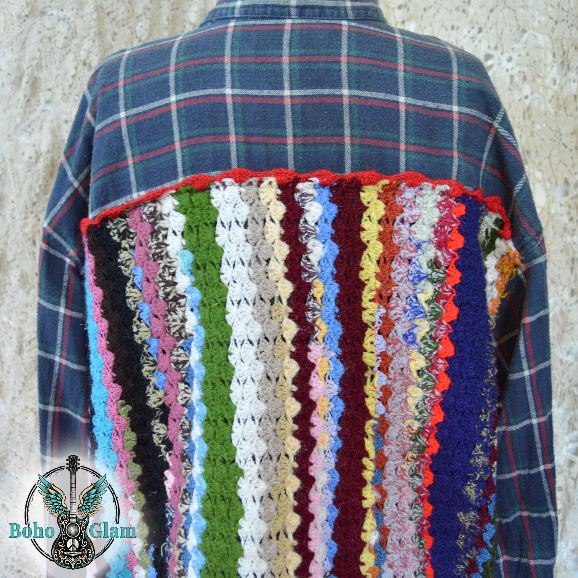 Close-up Back Detail: A detailed shot of the intricate crochet work on the back of the shirt, showcasing the varied textures and vibrant yarn colors used in the vertical striped design.