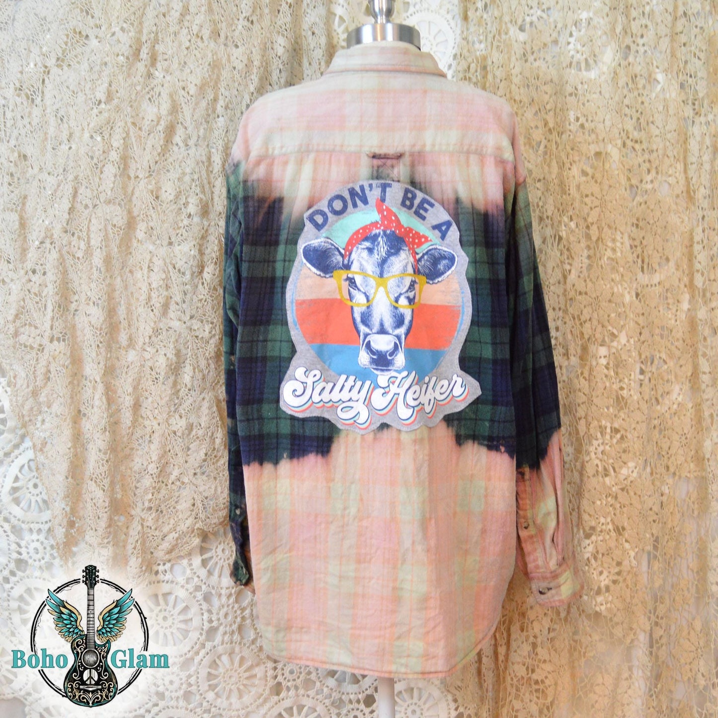 Back View: A Men's Large bleached plaid flannel shirt featuring a large back patch with a cow in glasses and the text "Don't Be A Salty Heifer."