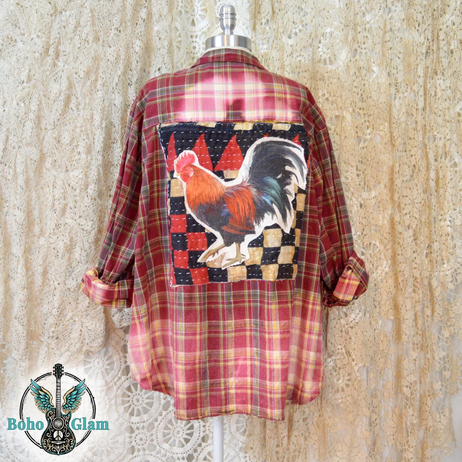 Back View on Mannequin: A red plaid flannel shirt featuring a large handcrafted rooster applique on the back with a custom dip bleached bottom hem.