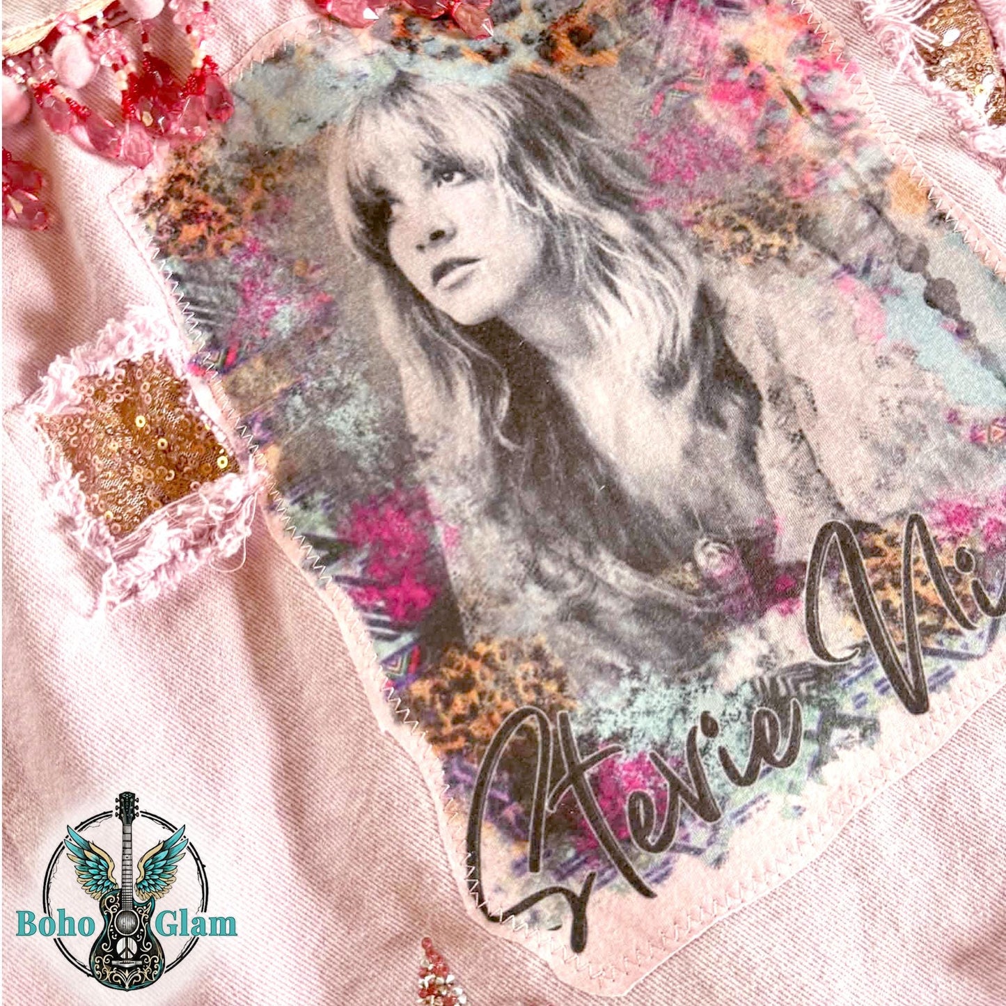 Close up of watercolor portrait graphic on pink denim jacket with sequin patch detail and textured embellishments, Stevie Nicks inspired boho glam design