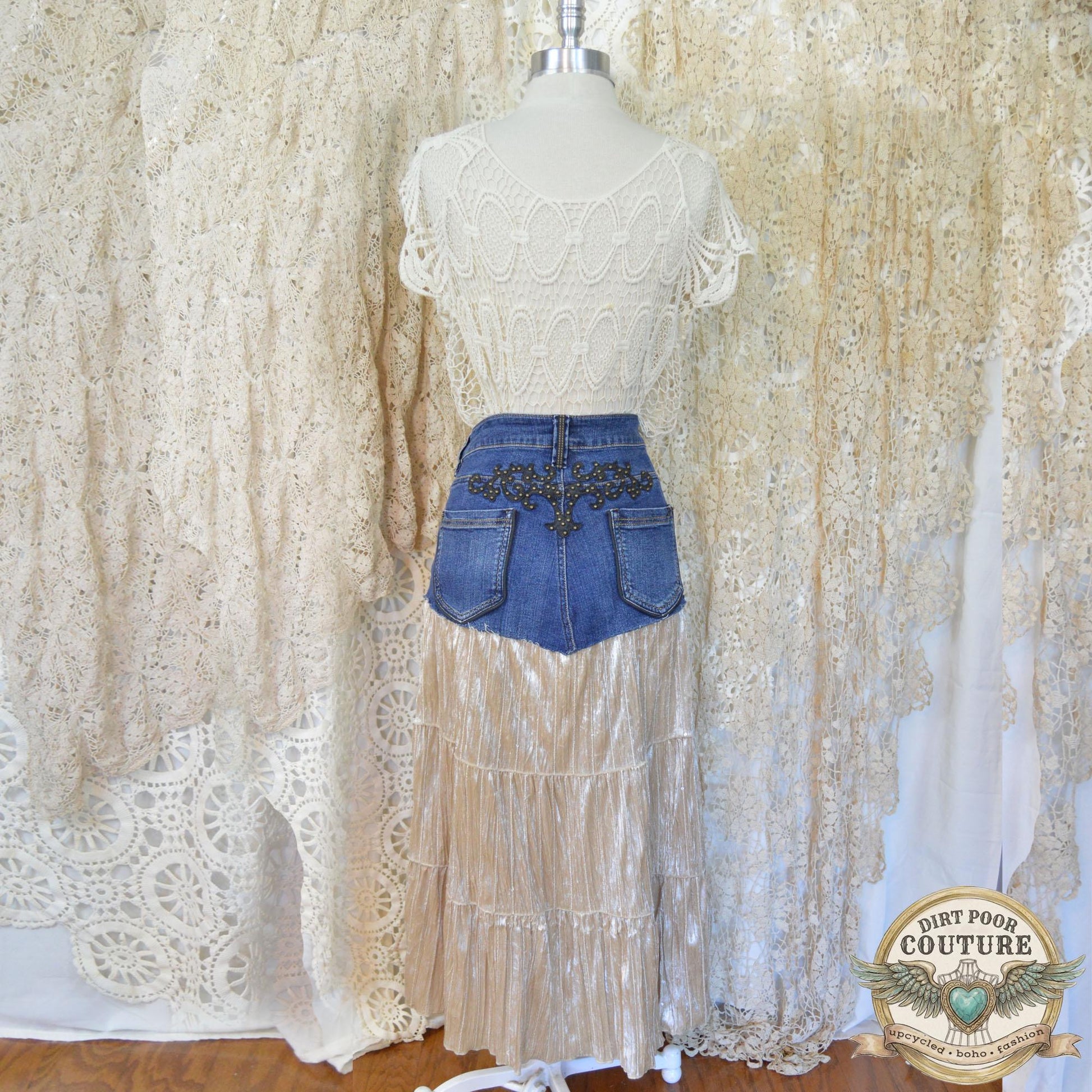 Rear view of the skirt on the mannequin, highlighting the authentic denim stitching and the studded detailing on the back pockets