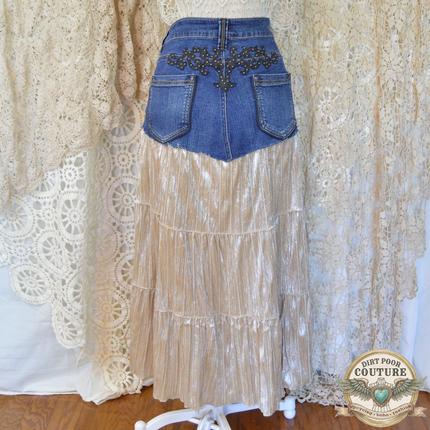 Rear view of the skirt on the mannequin, highlighting the authentic denim stitching and the studded detailing on the back pockets
