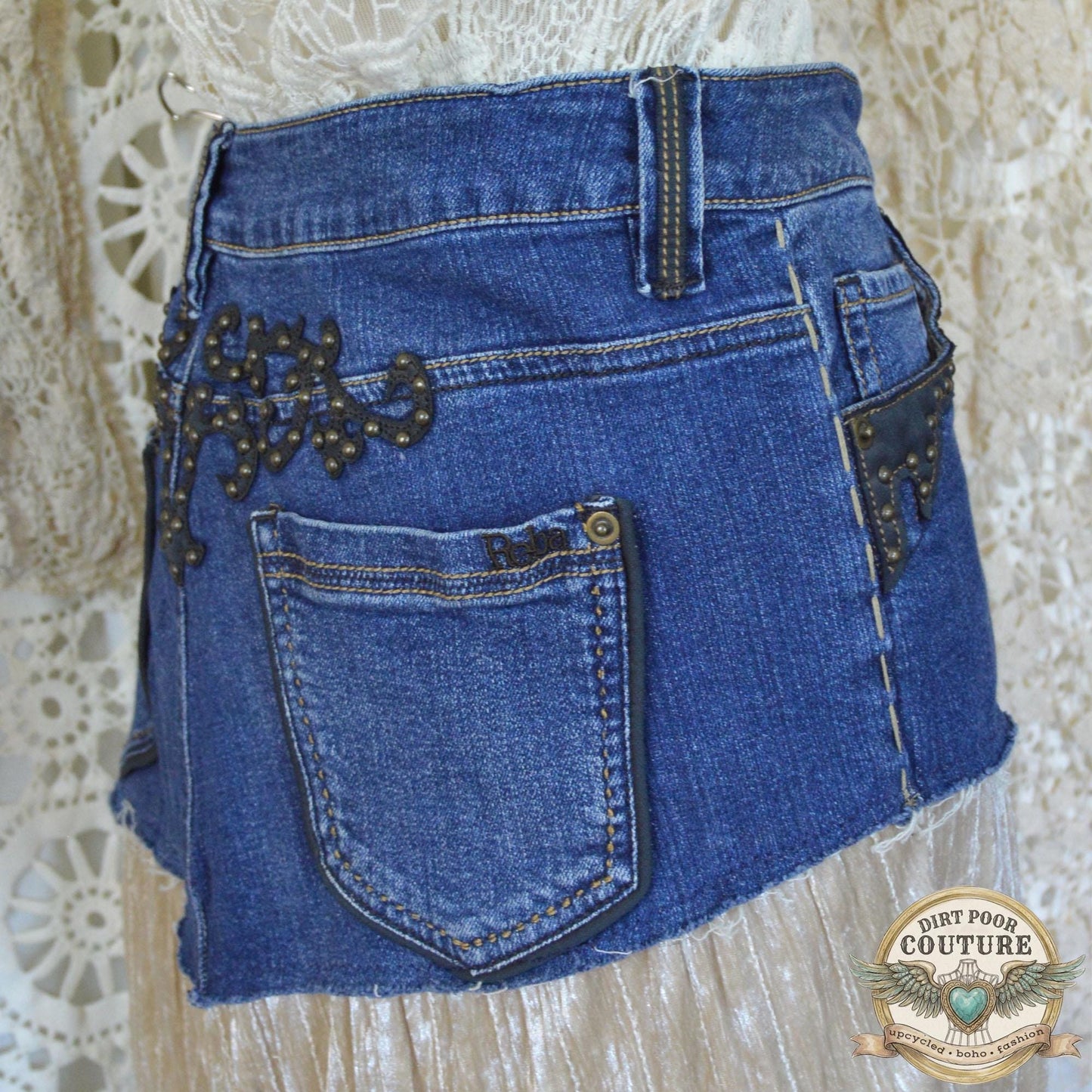 Rear view of the skirt on the mannequin, highlighting the authentic denim stitching and the studded detailing on the back pockets