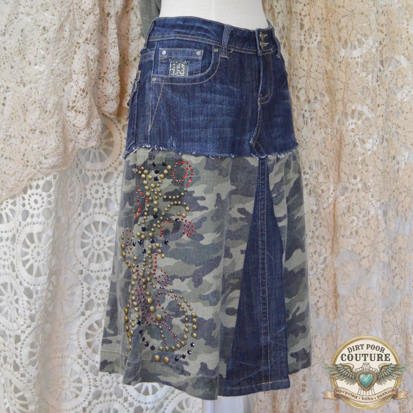 Close-up of the immaculate metal studding and sparkling rhinestone embellishments on the dark denim and camouflage background.