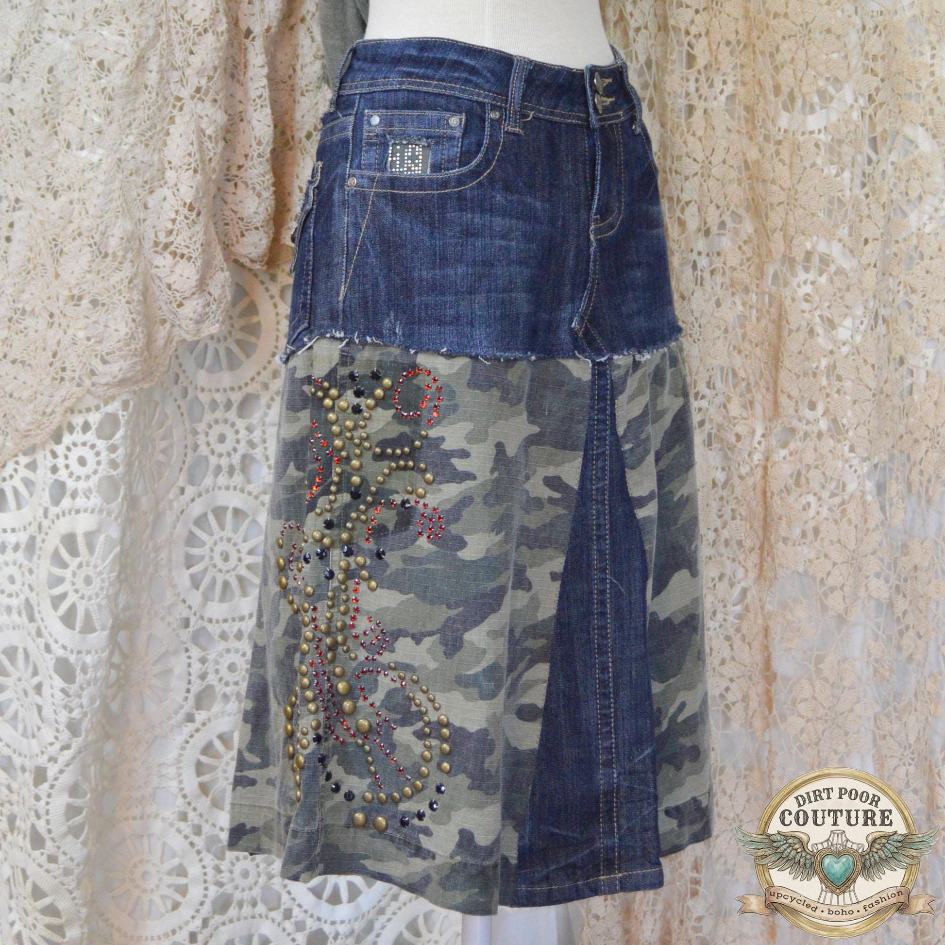 Close-up of the immaculate metal studding and sparkling rhinestone embellishments on the dark denim and camouflage background.