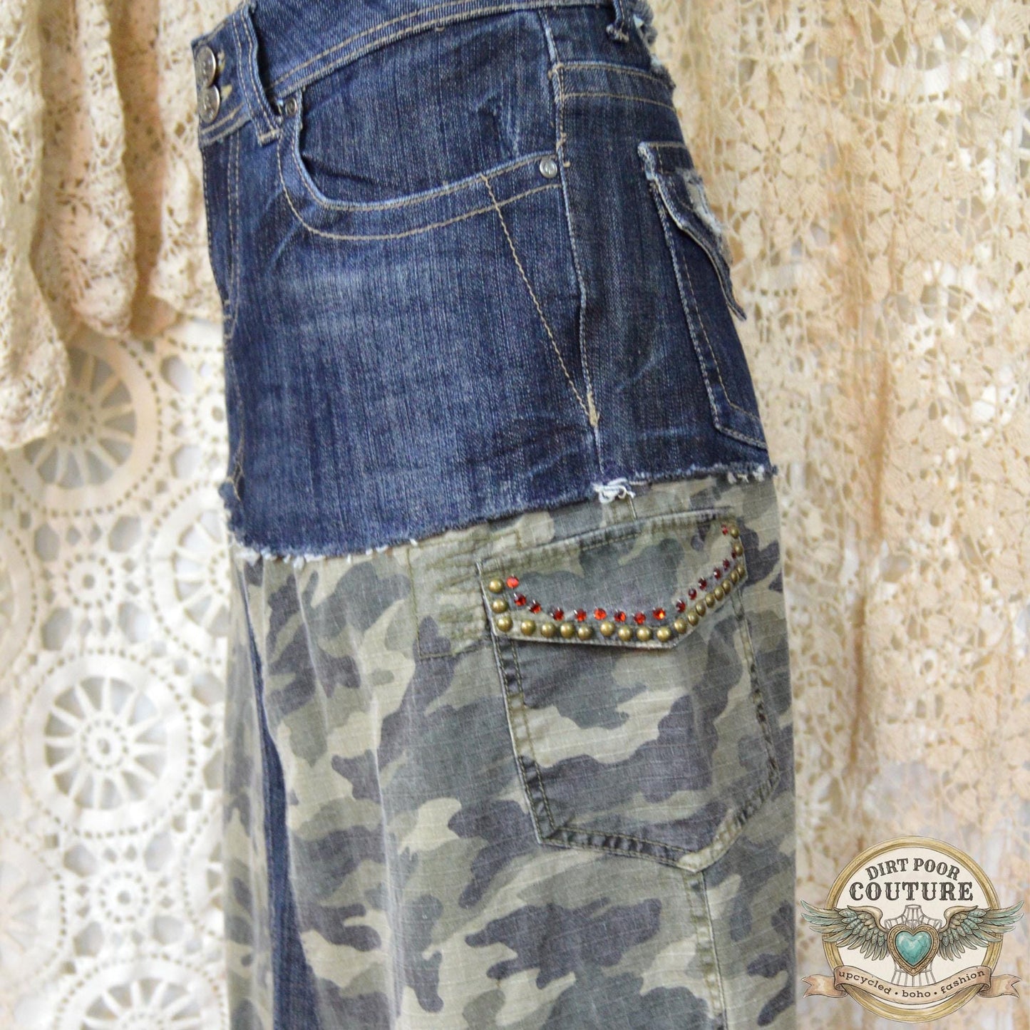 Close-up of the immaculate metal studding and sparkling rhinestone embellishments on the dark denim and camouflage background.