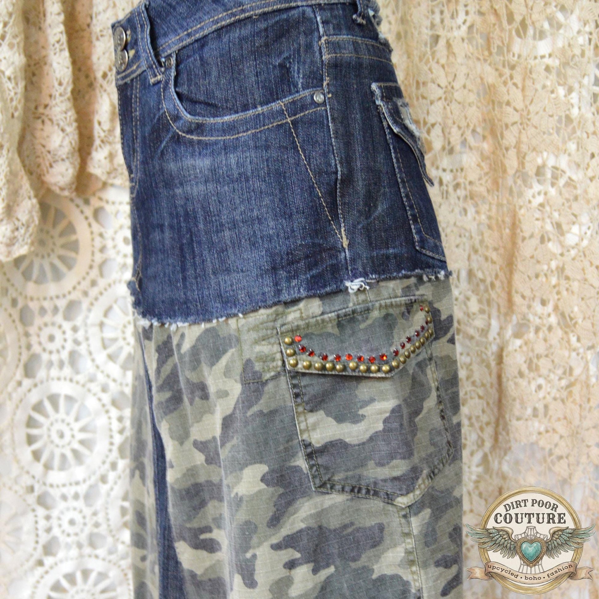 Close-up of the immaculate metal studding and sparkling rhinestone embellishments on the dark denim and camouflage background.