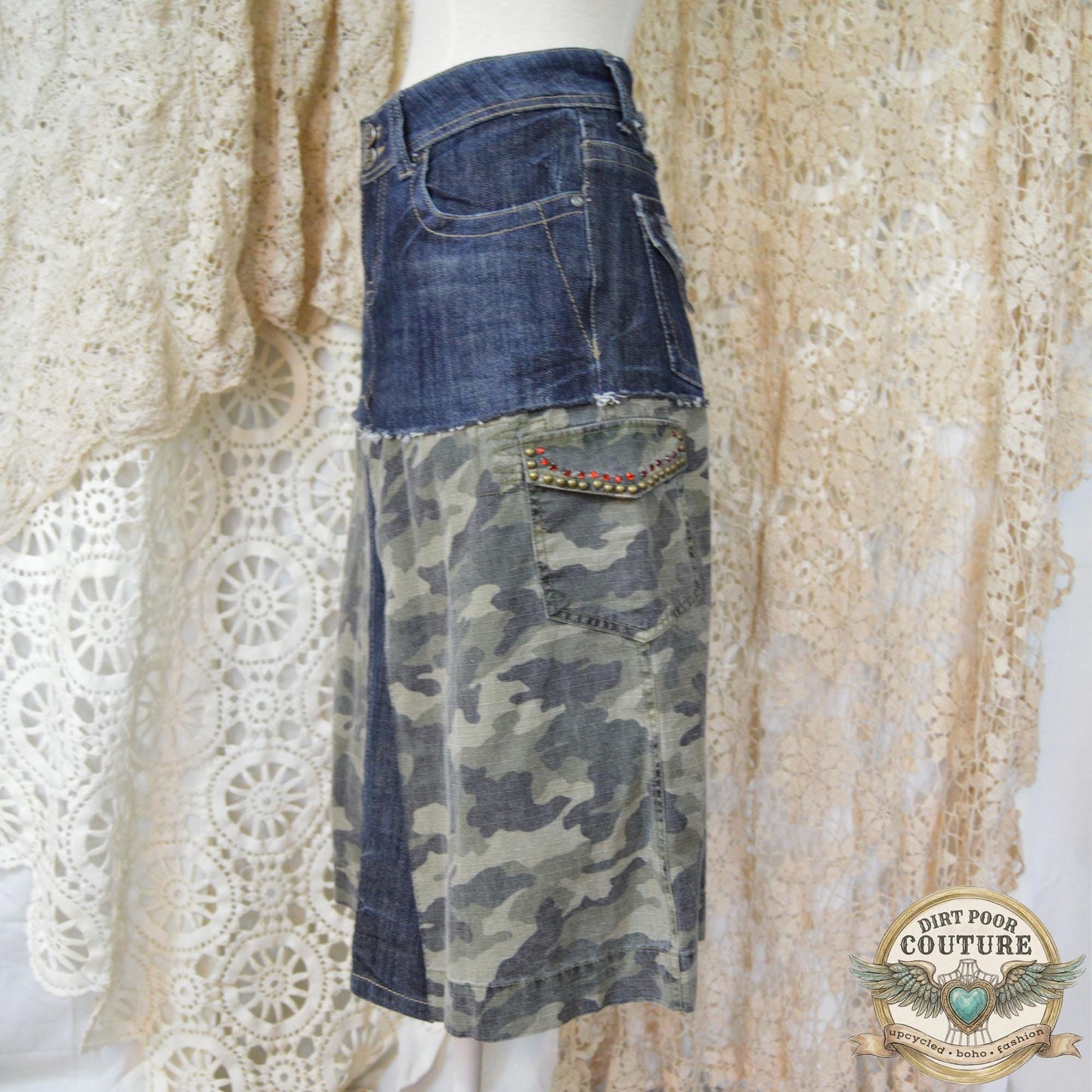Close-up of the immaculate metal studding and sparkling rhinestone embellishments on the dark denim and camouflage background.
