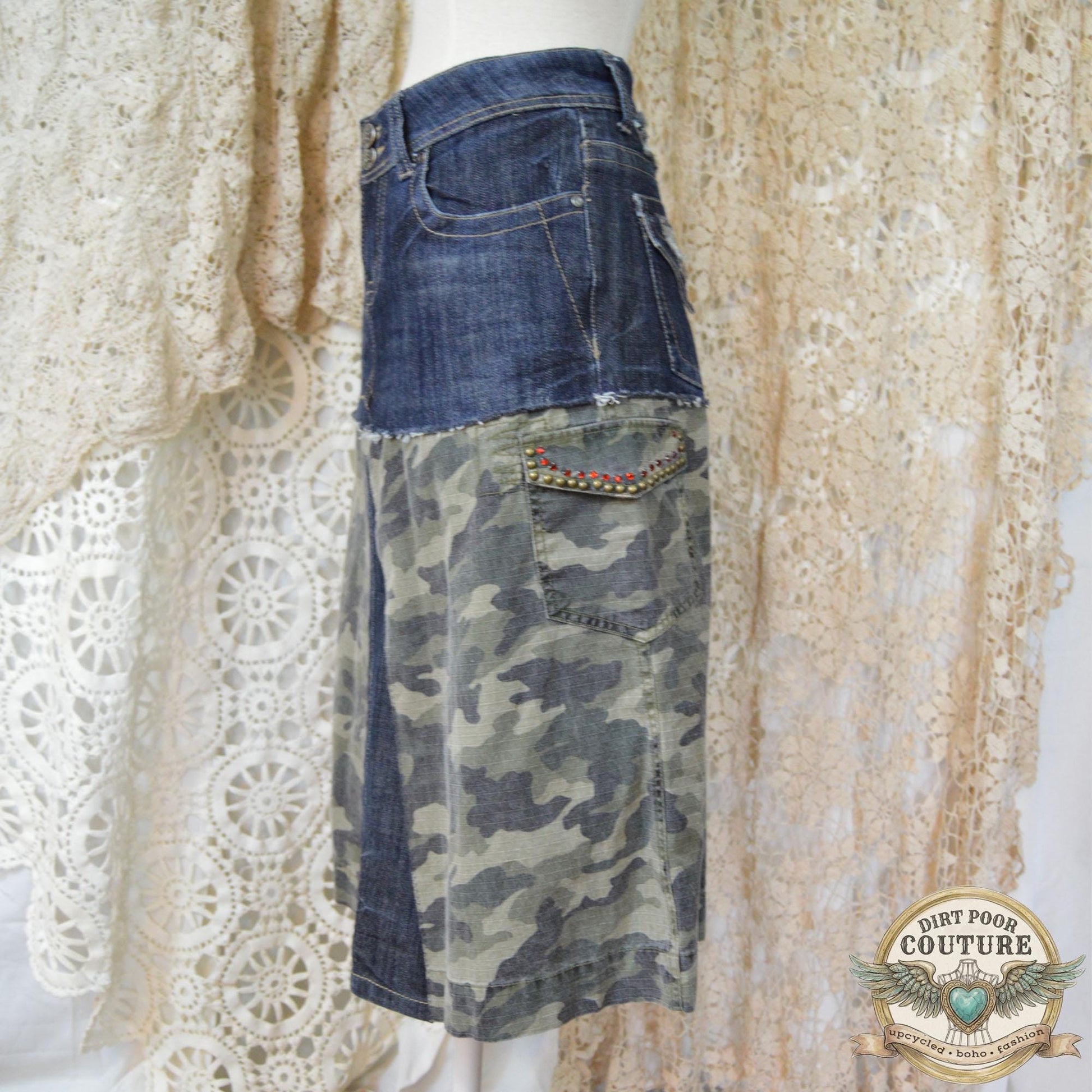 Close-up of the immaculate metal studding and sparkling rhinestone embellishments on the dark denim and camouflage background.
