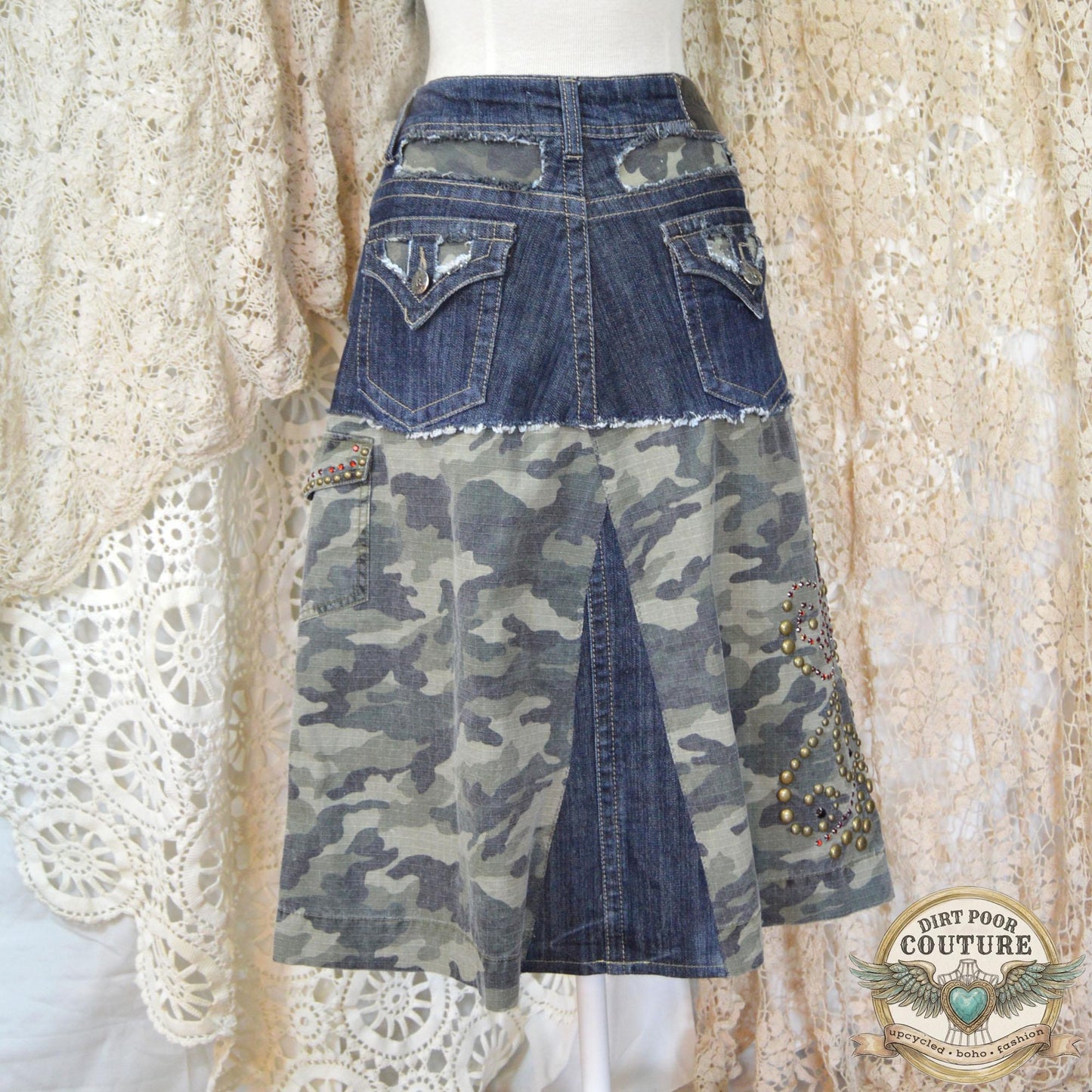 The back of the denim skirt showing the tailored fit and continuation of the camo accents and structural stitching.