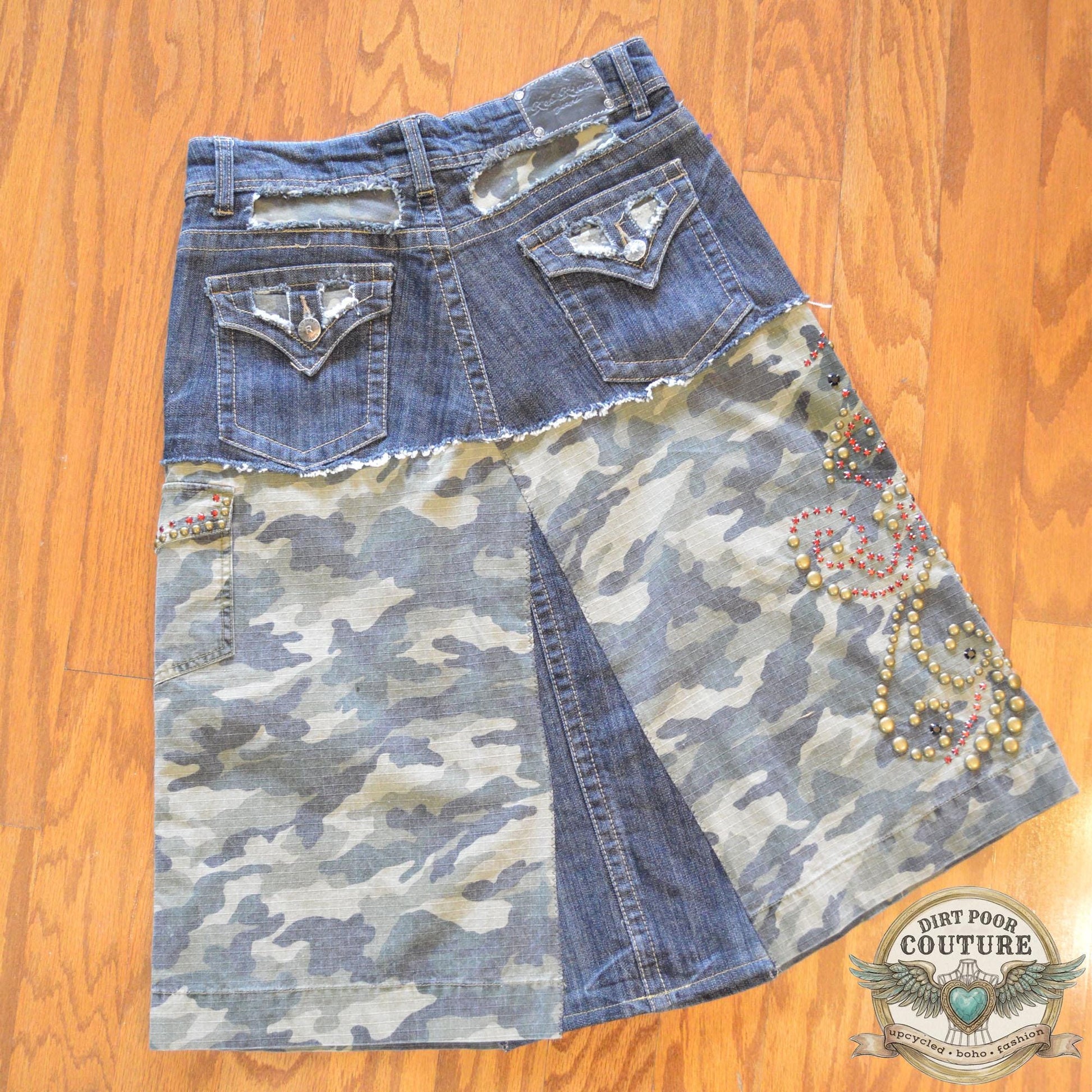 The back of the denim skirt showing the tailored fit and continuation of the camo accents and structural stitching.