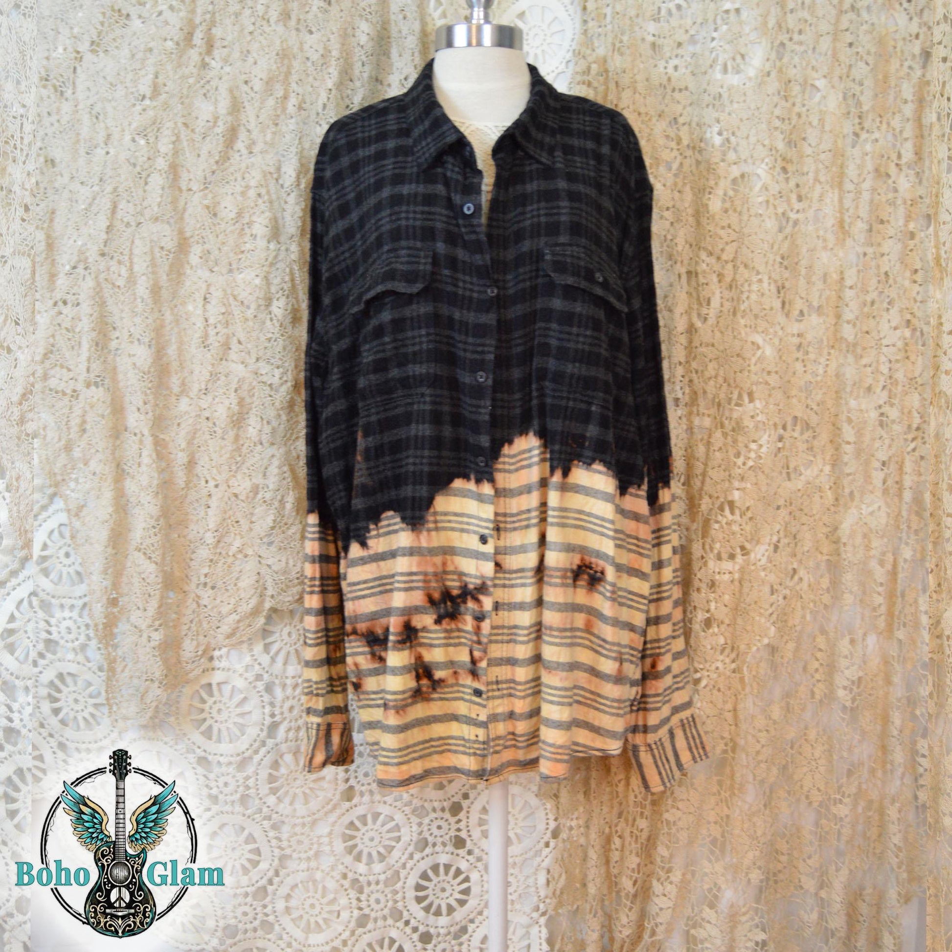 The front of a distressed black plaid flannel with a dip-bleach effect and button-down pockets on a mannequin
