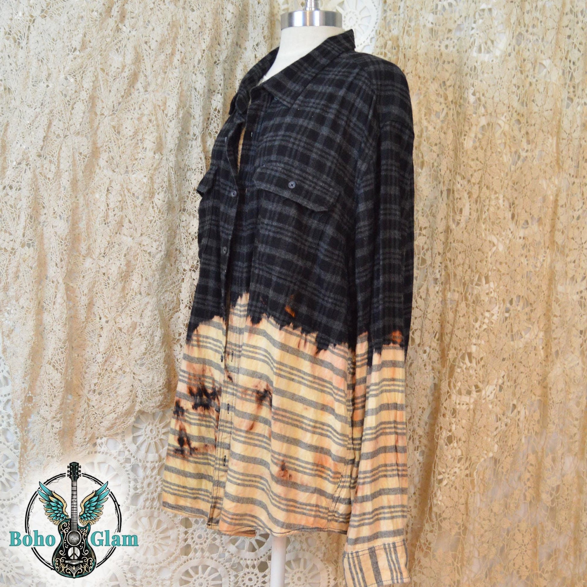The front of a distressed black plaid flannel with a dip-bleach effect and button-down pockets on a mannequin