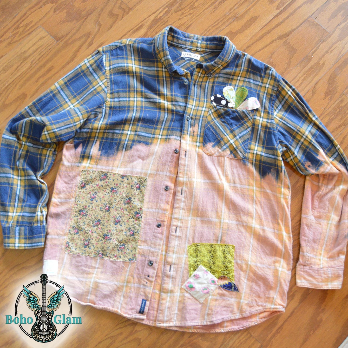 Front View: The front of a bleached plaid flannel shirt on a mannequin showing colorful floral patchwork and heart appliques on the chest pocket.