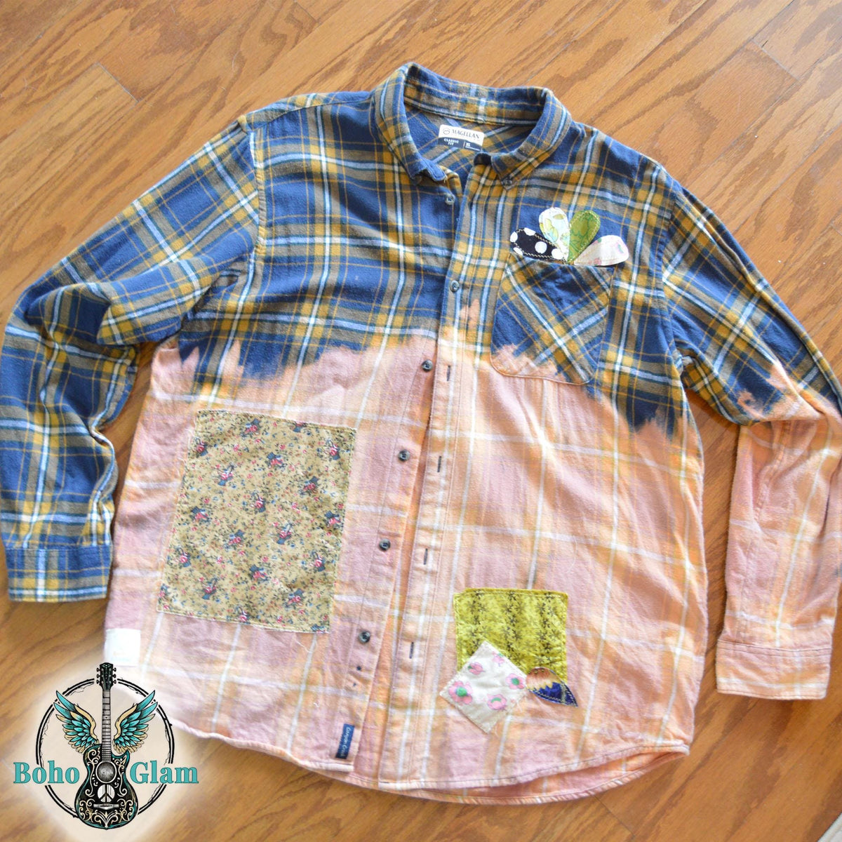Front View: The front of a bleached plaid flannel shirt on a mannequin showing colorful floral patchwork and heart appliques on the chest pocket.