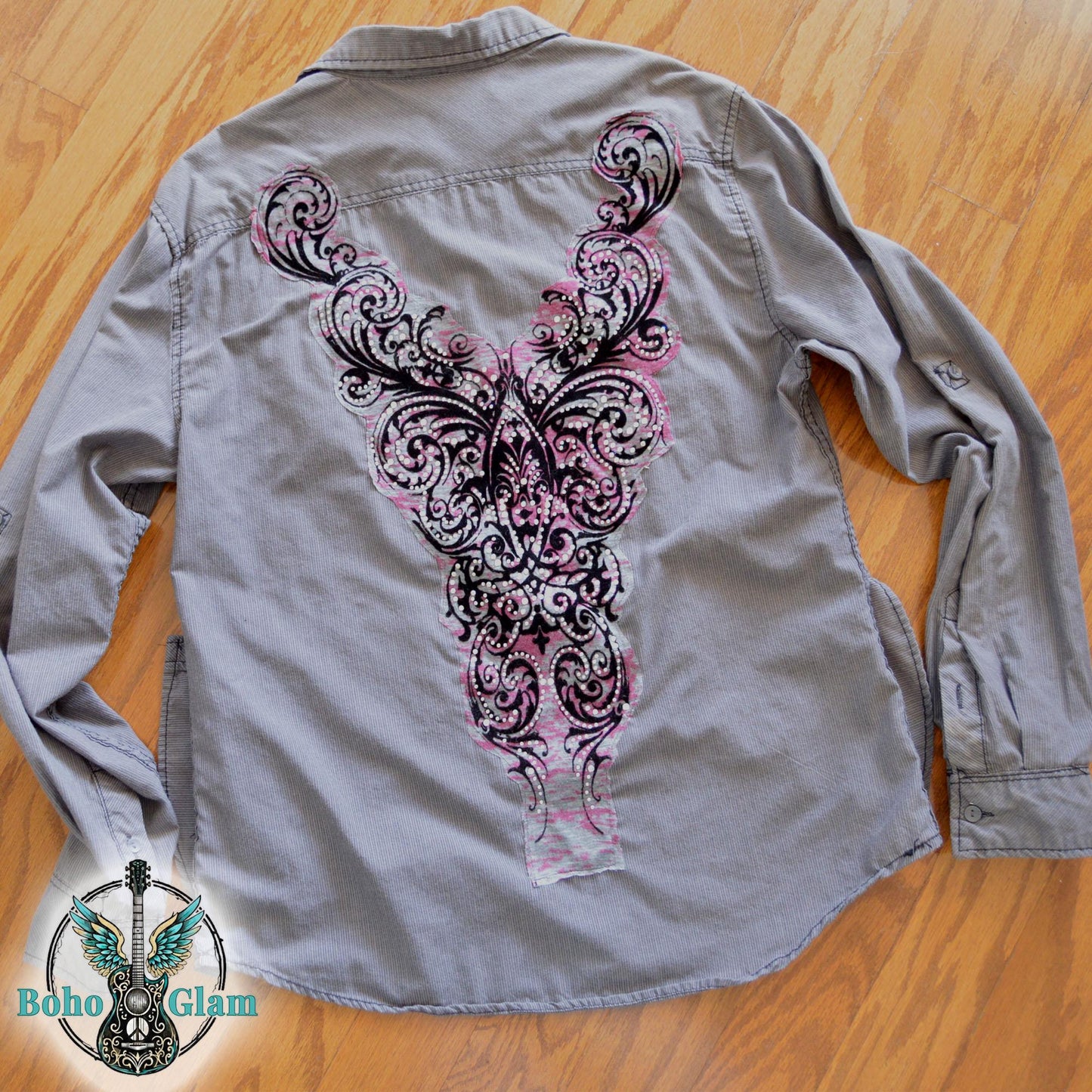 A charcoal gray corduroy button down shirt featuring a large pink and black filigree applique embellished with clear rhinestones.