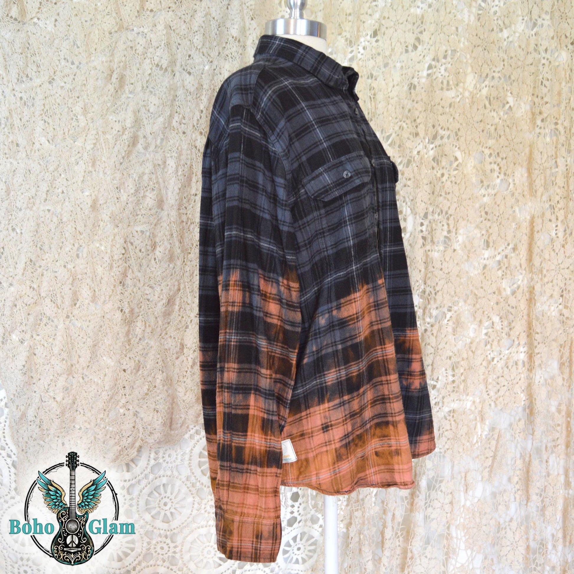 mannequin display showing the long sleeves and the striking color transition from dark charcoal plaid to bleached orange.
