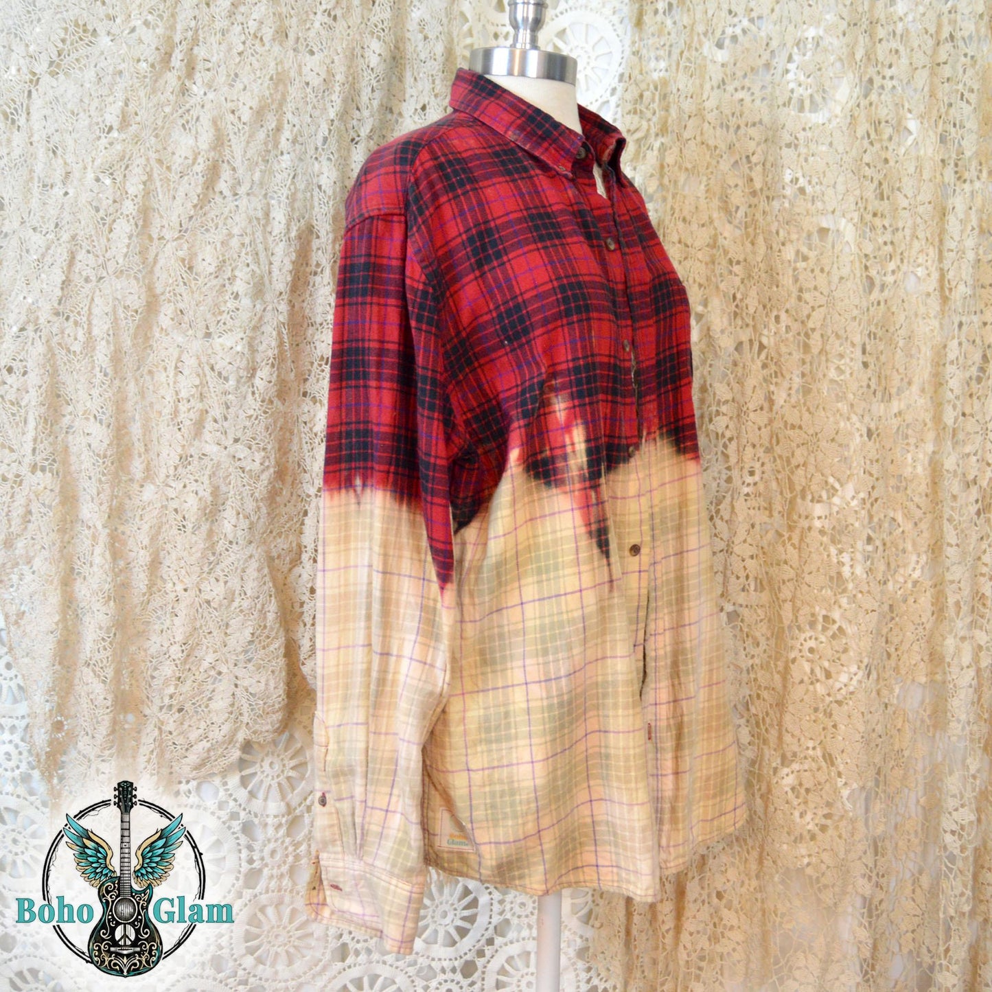 A profile shot of the shirt on a mannequin, showing the jagged, hand-dipped bleach line and the long sleeve with a button cuff.