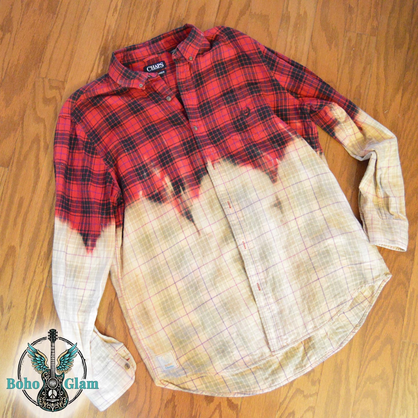 The front of the button-down flannel, showing the red plaid pattern across the chest and shoulders fading into a bleached cream grid pattern on the lower half.