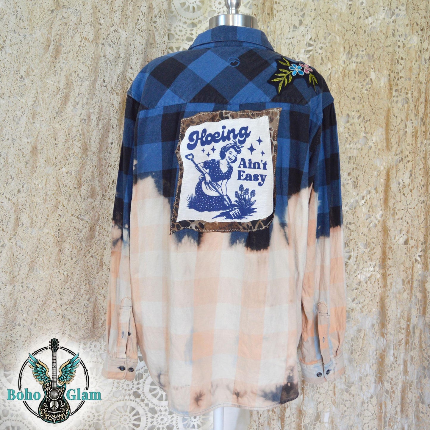 Full Back View: The back of a bleached blue and black checkered flannel shirt on a mannequin highlighting the large graphic applique and custom dip-bleach effect.