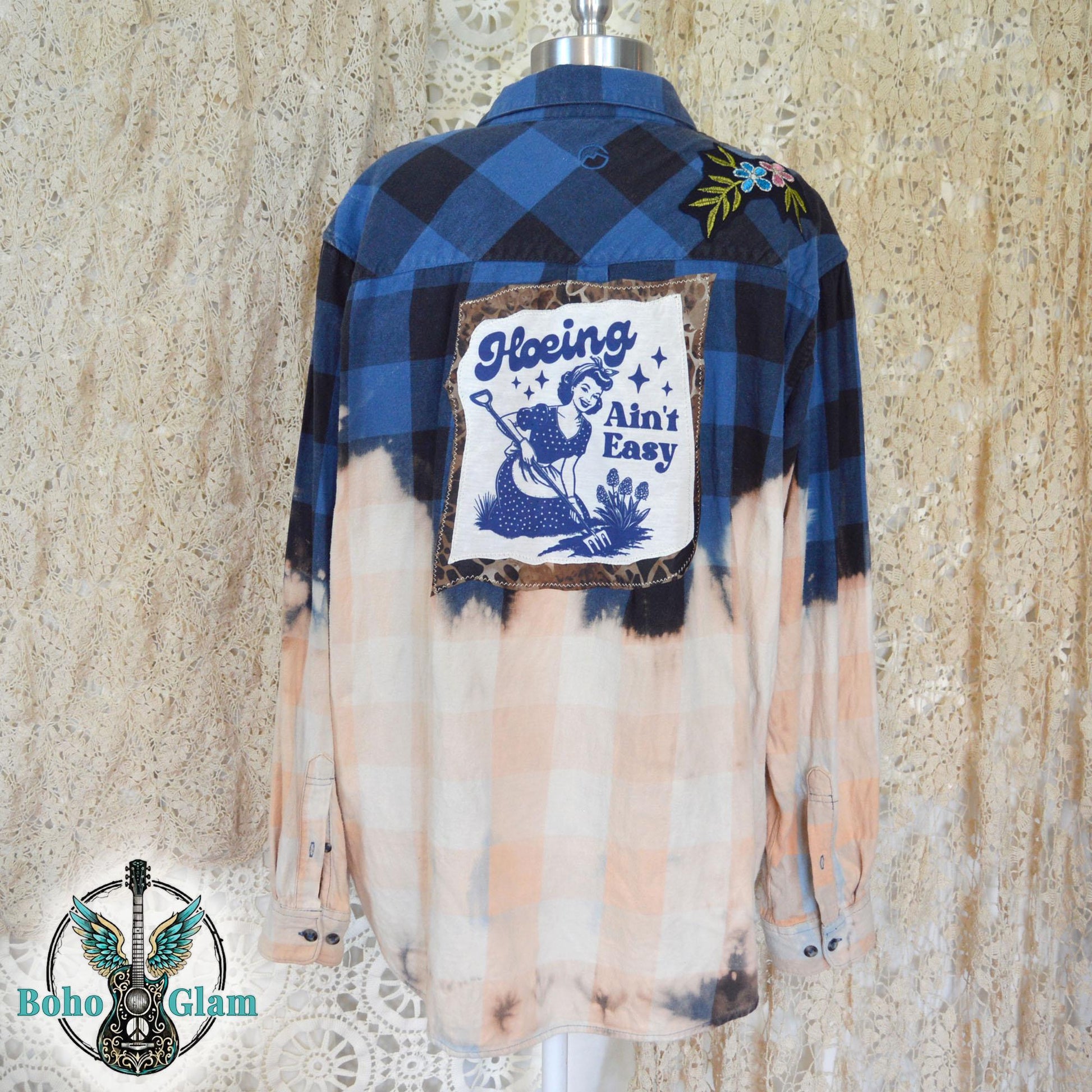 Full Back View: The back of a bleached blue and black checkered flannel shirt on a mannequin highlighting the large graphic applique and custom dip-bleach effect.
