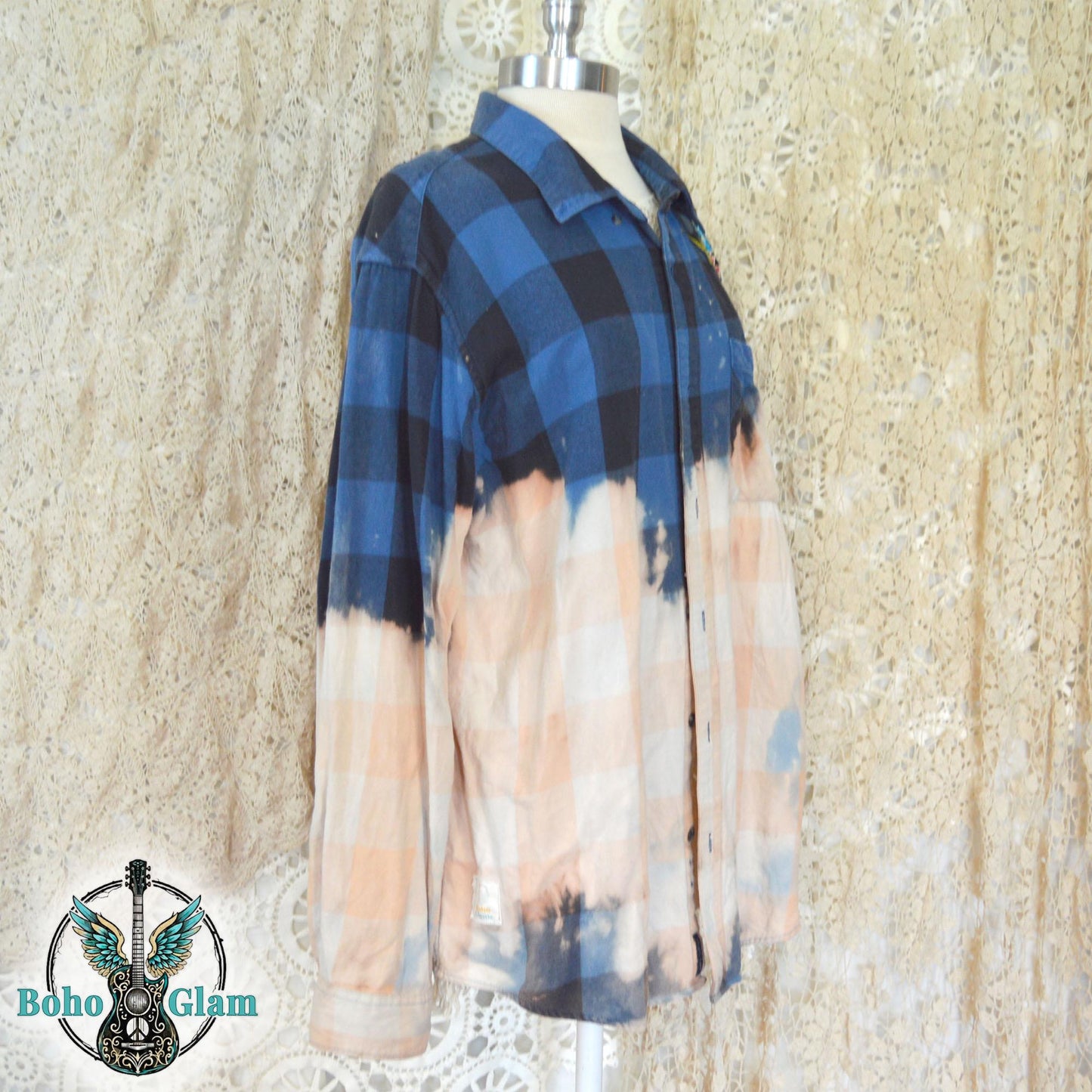 Side View: A mannequin display showing the side profile of the upcycled flannel and the dramatic jagged bleach line transitioning from blue to cream.