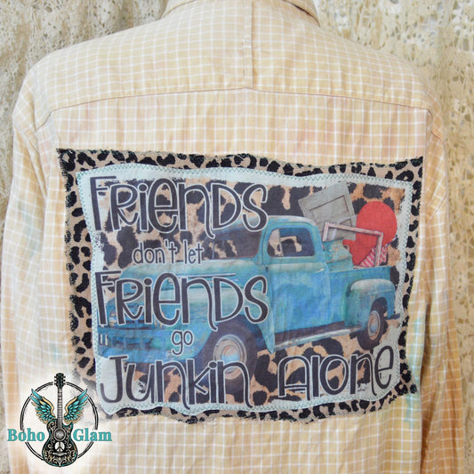 Graphic Detail: Close-up of the back applique featuring a blue vintage truck filled with antiques and the text Friends don't let Friends go Junkin Alone.