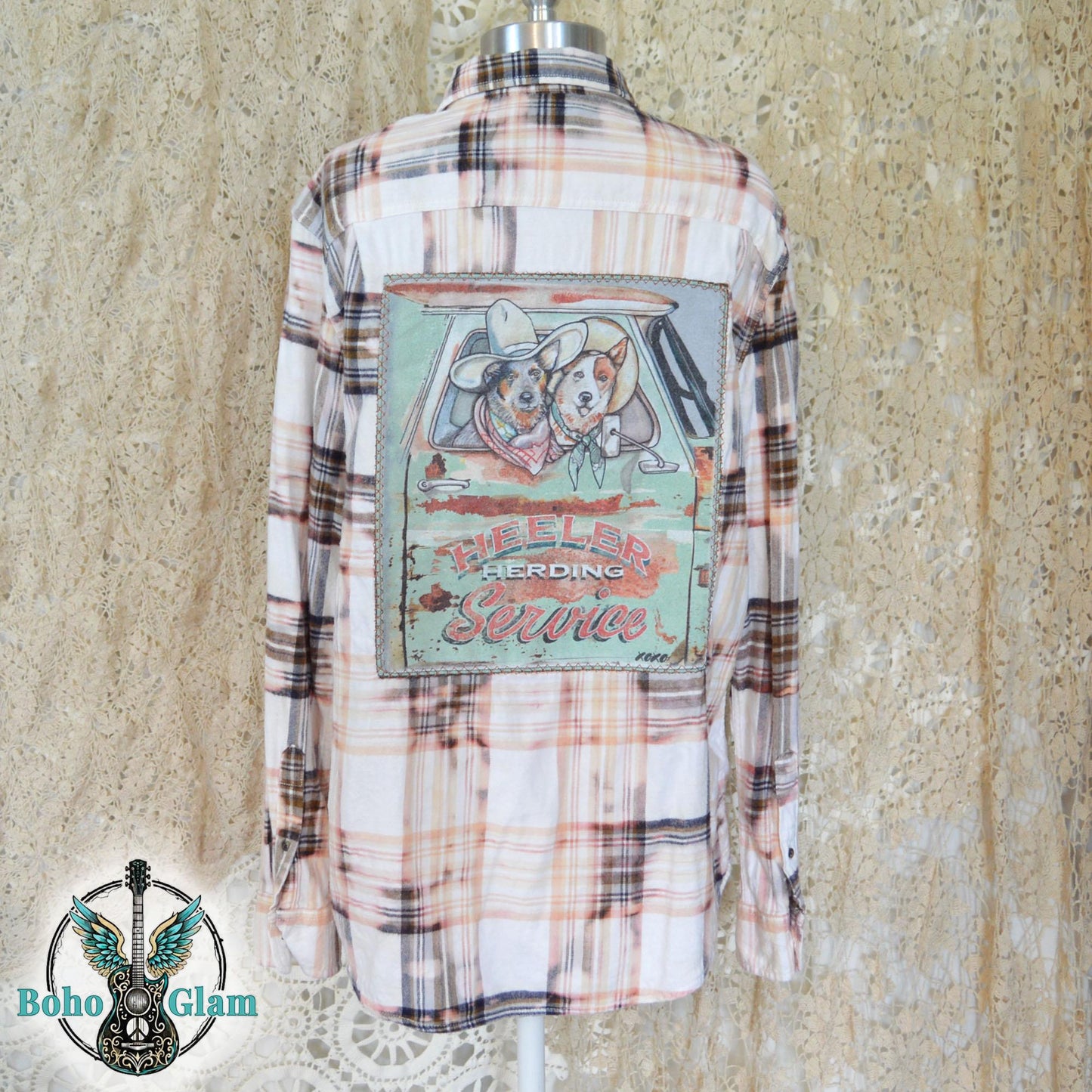 Back View: A Men's Large bleached plaid flannel shirt featuring a large back patch with two cattle dogs in a vintage truck and "Heeler Herding Service" text.