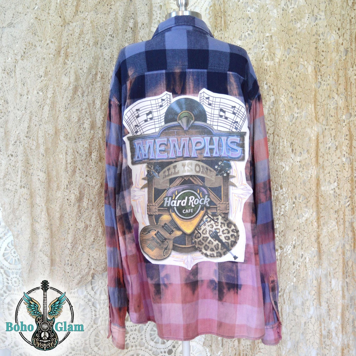 Back View on Mannequin: The back of the shirt on a mannequin, showcasing the full scale of the Memphis music graphic and the rich navy plaid at the shoulders.