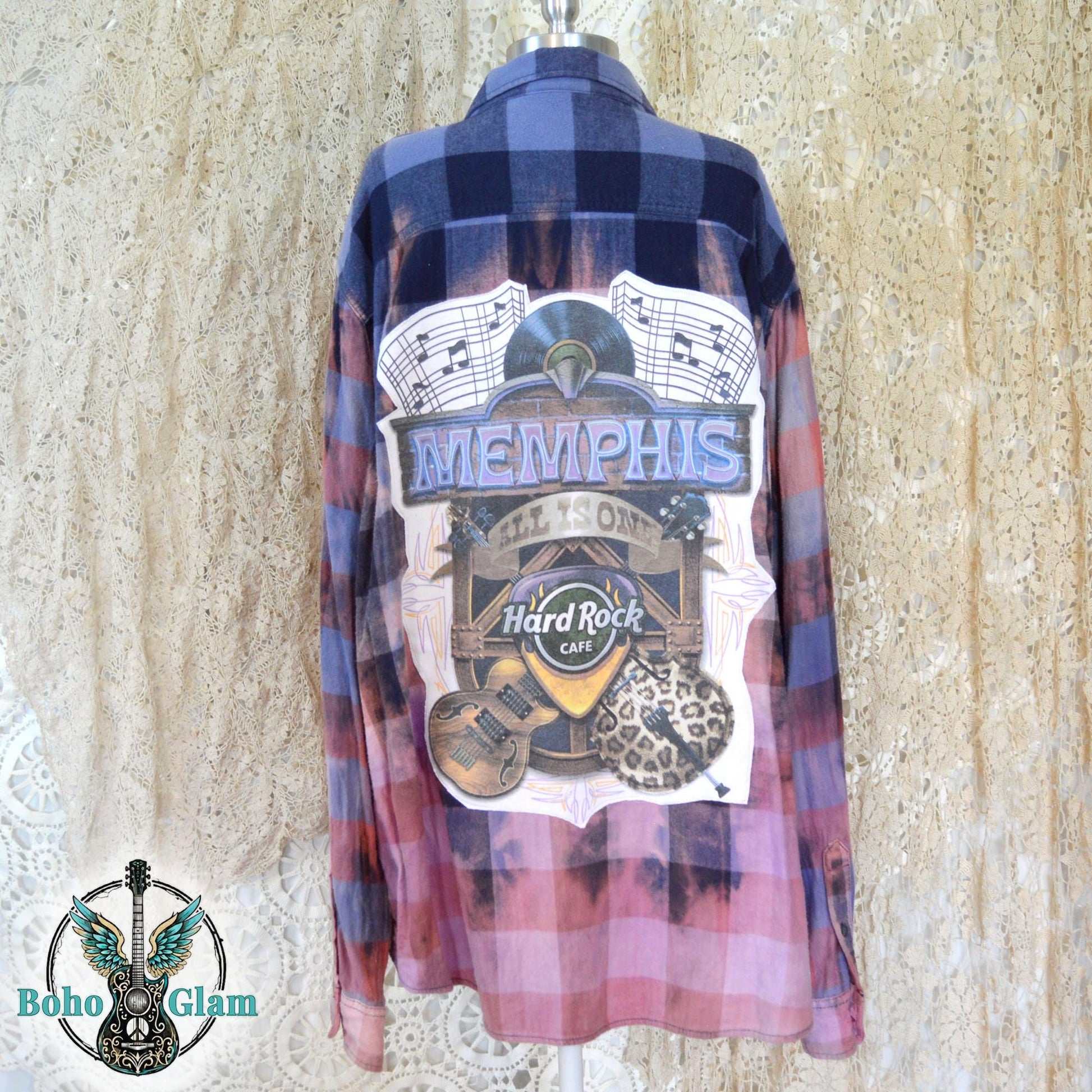 Back View on Mannequin: The back of the shirt on a mannequin, showcasing the full scale of the Memphis music graphic and the rich navy plaid at the shoulders.