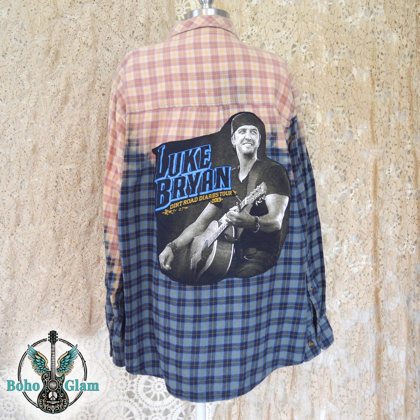 Full Back View: Rear view of the flannel on a mannequin highlighting the large graphic of Luke Bryan playing guitar against the bleached peach plaid.